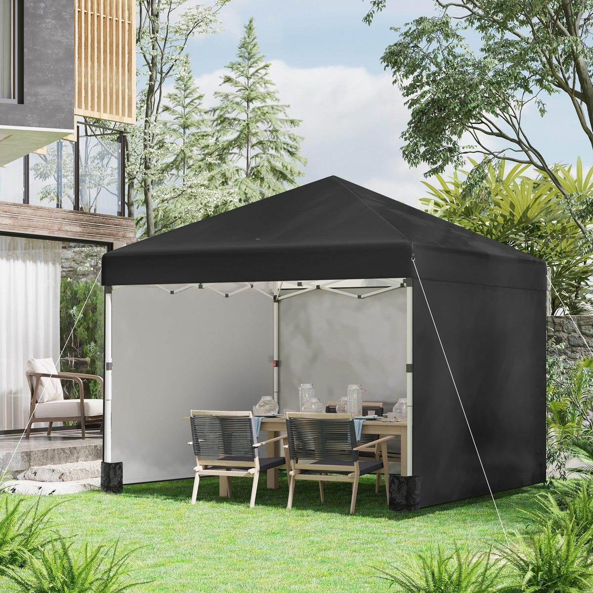 Black pop-up gazebo with two sidewalls and open entrance, set up in backyard