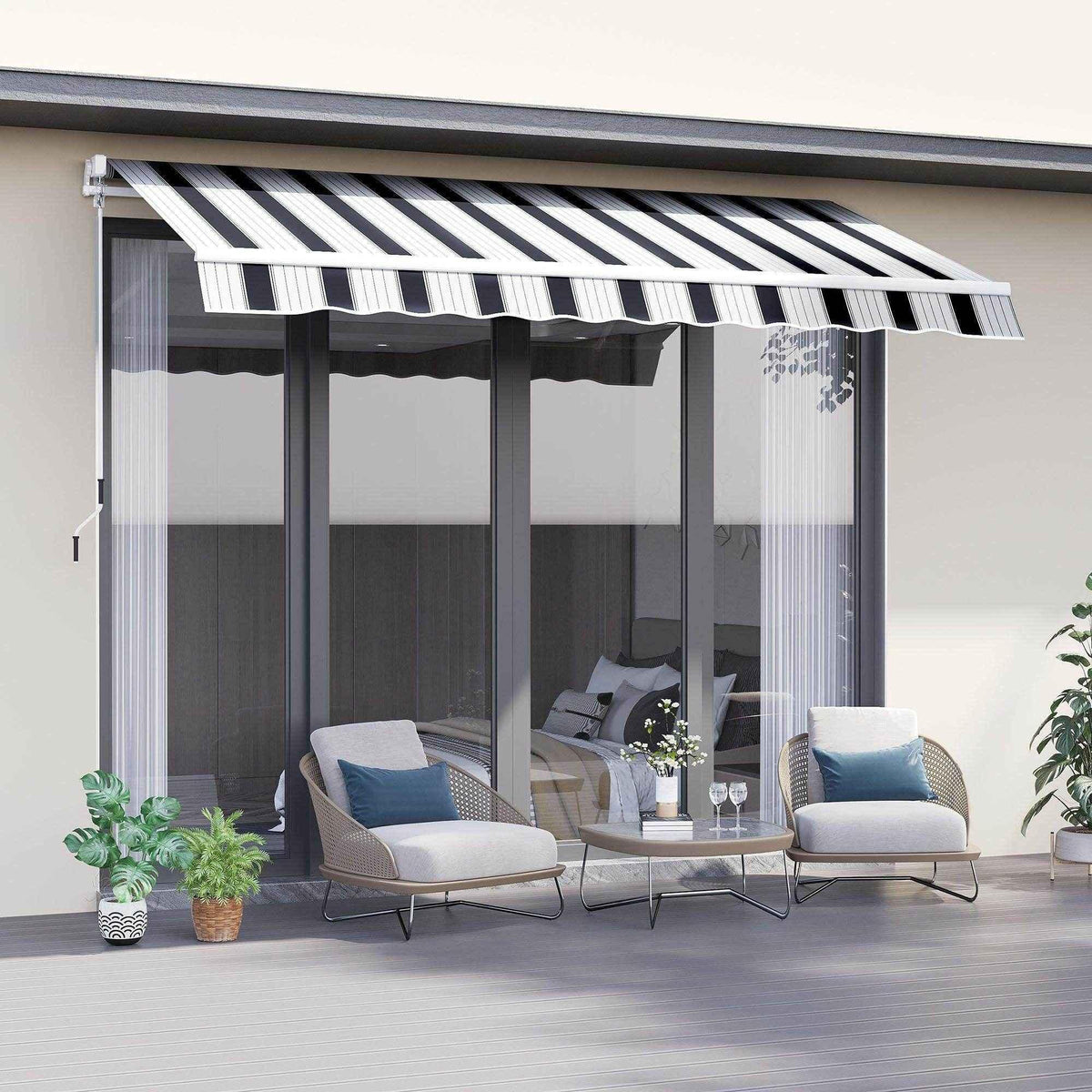 Black and white striped patio awning over modern outdoor seating with potted plants on deck