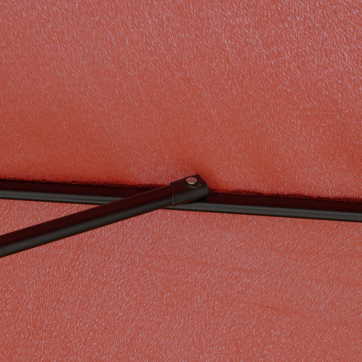 Wine red umbrella canopy close-up with fabric texture and tie strap