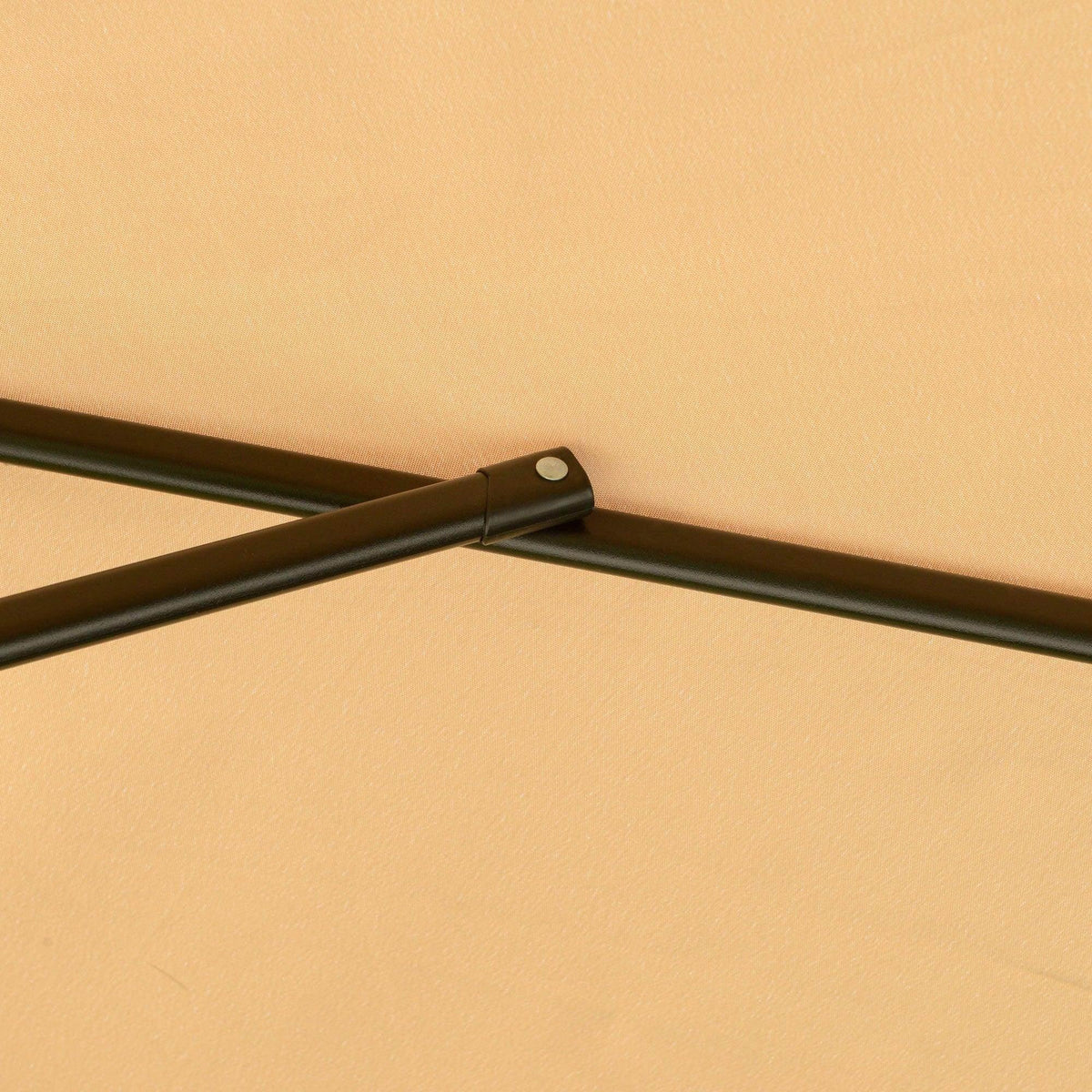 Cream canopy fabric corner with black metal support arm and joint