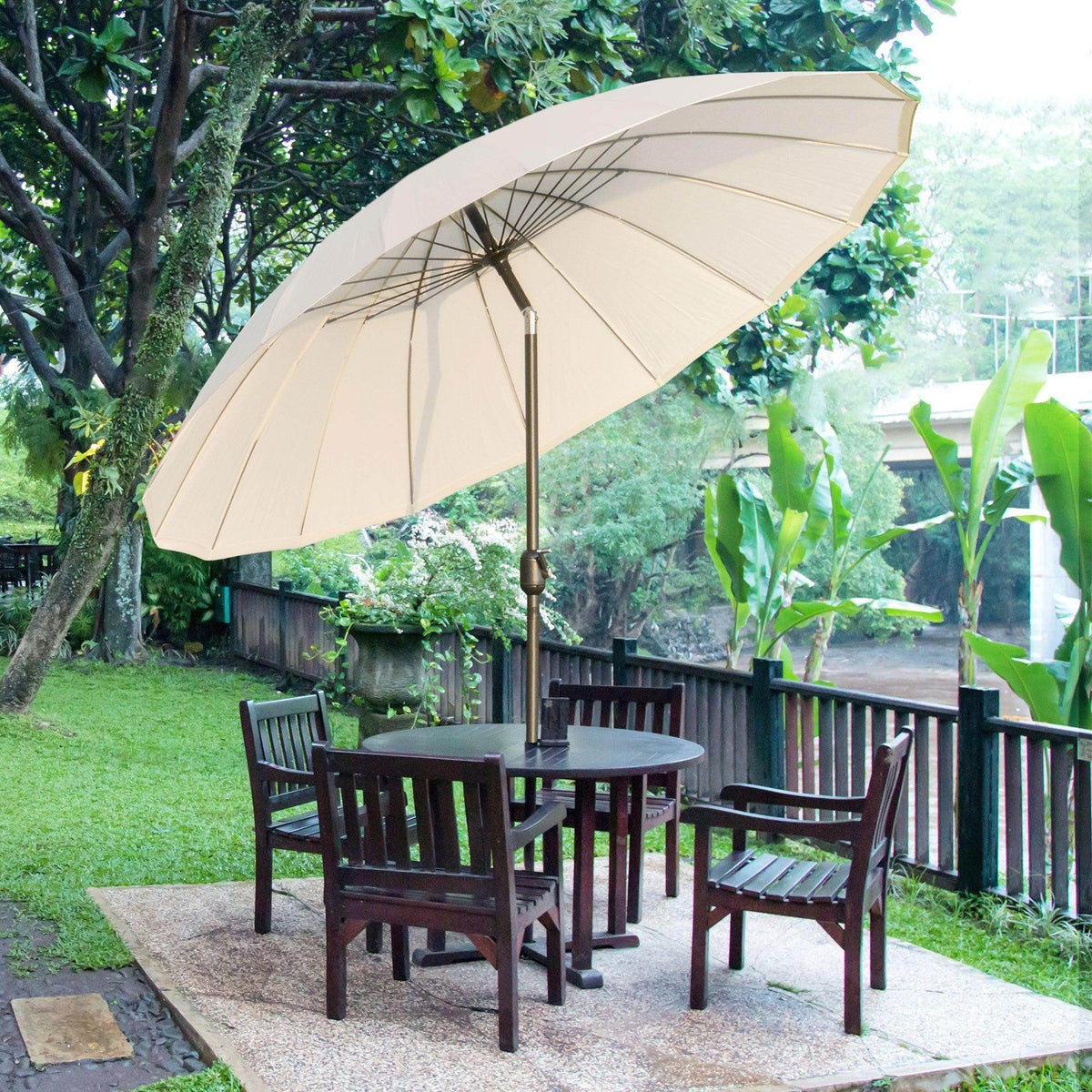 Outdoor patio umbrella with off-white canopy and metal pole, open umbrella view