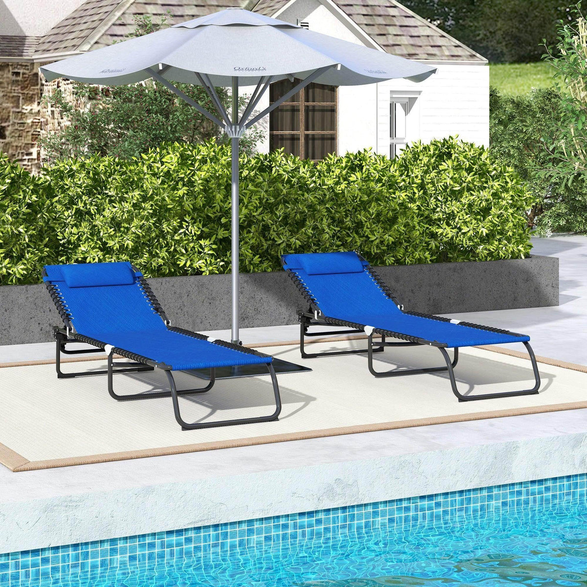 Two blue folding sun loungers with adjustable backs and black frames near a pool
