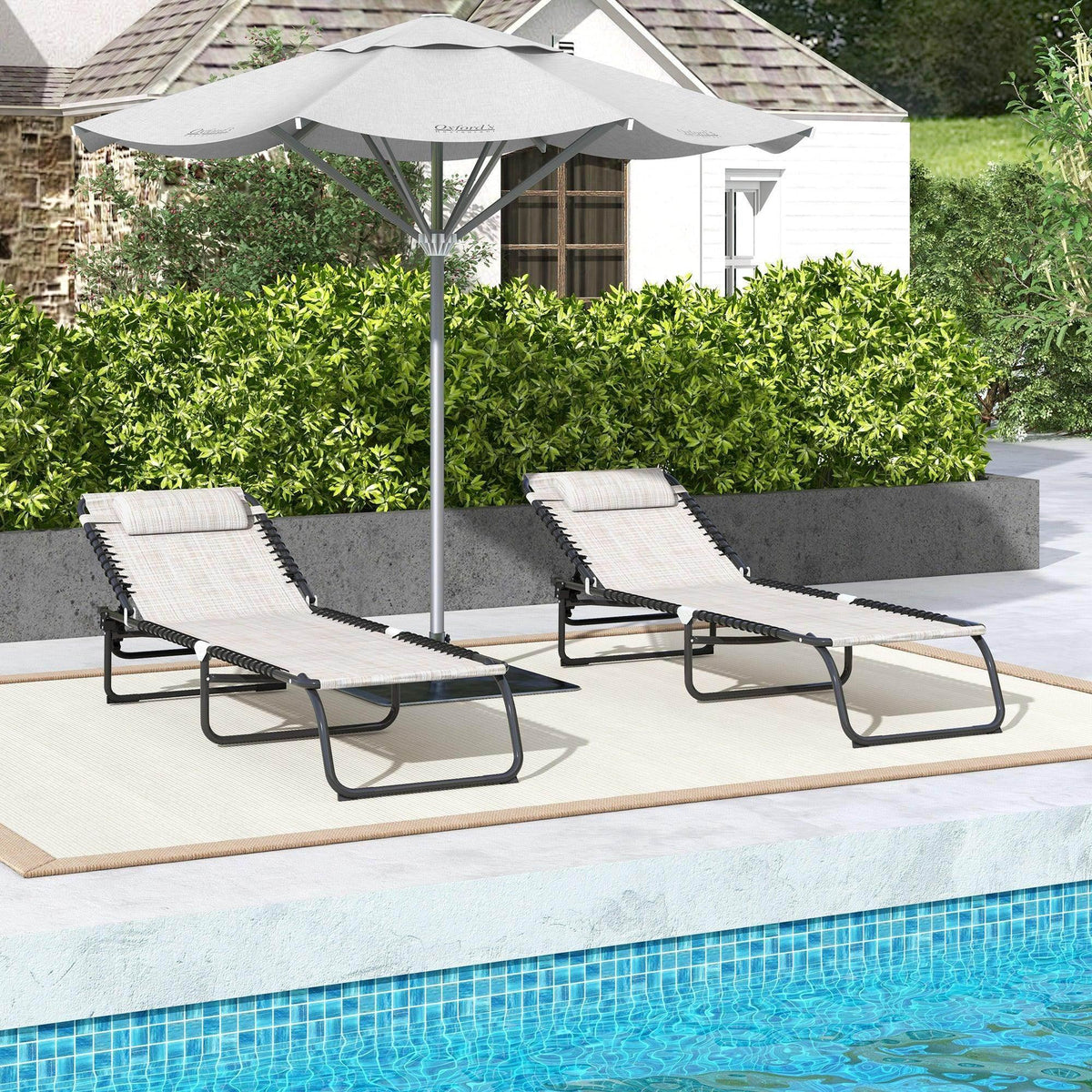 Two cream mesh folding loungers with black adjustable backrests near a pool