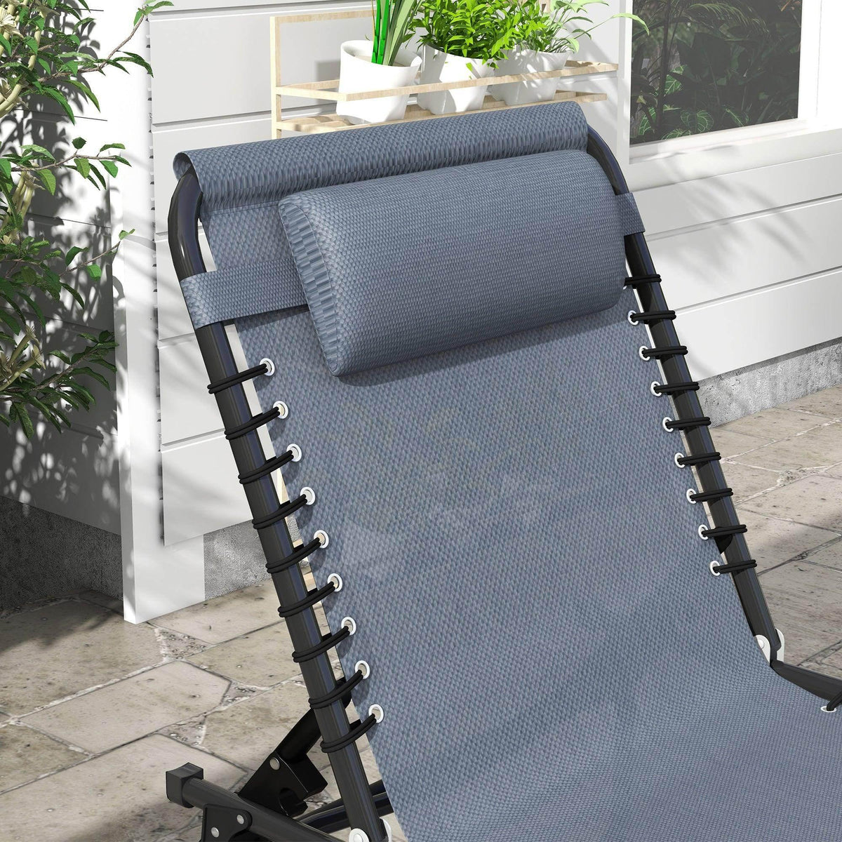 Grey mesh sun lounger with padded headrest and adjustable backrest bars on black frame