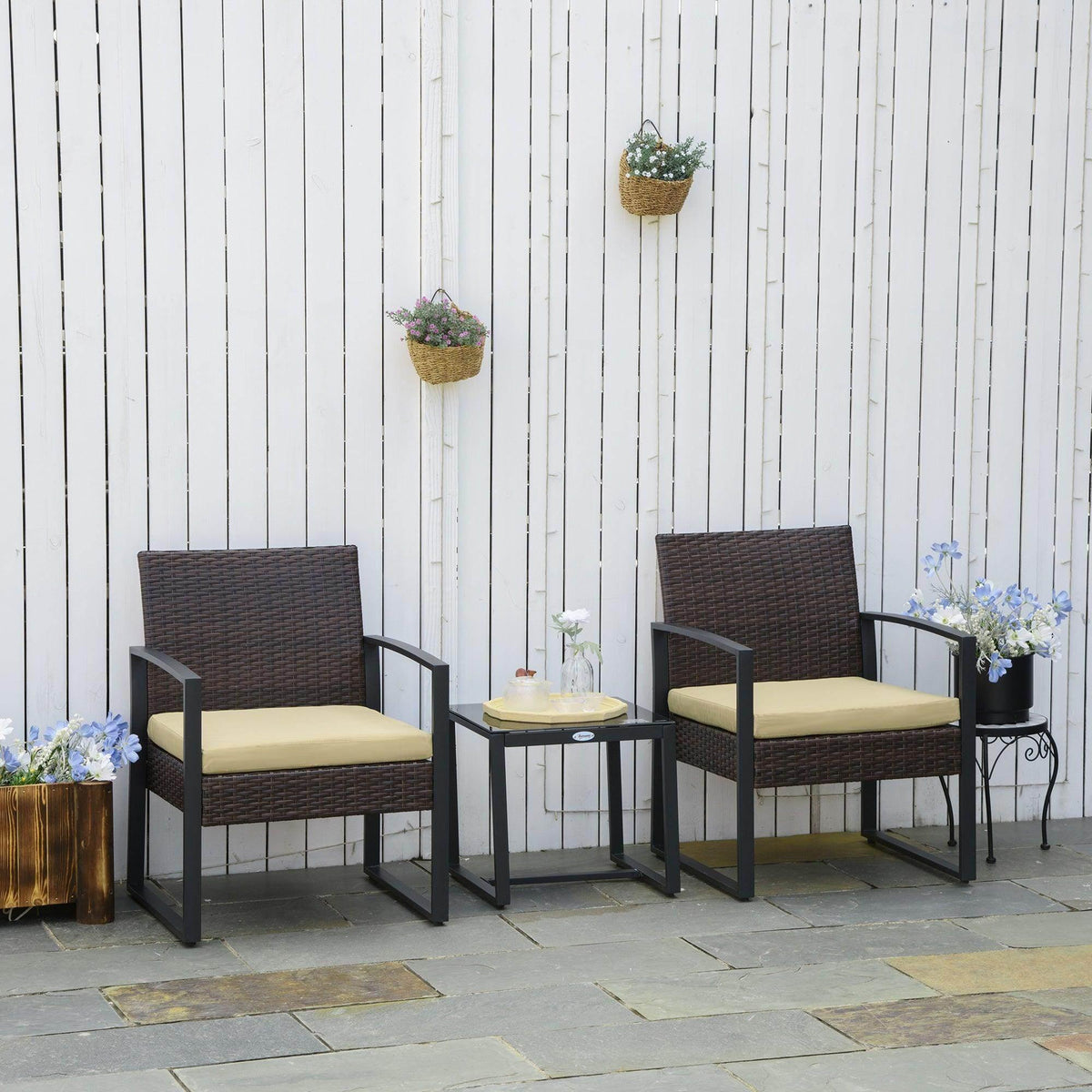 Beige patio bistro set with two wicker chairs and a square coffee table.