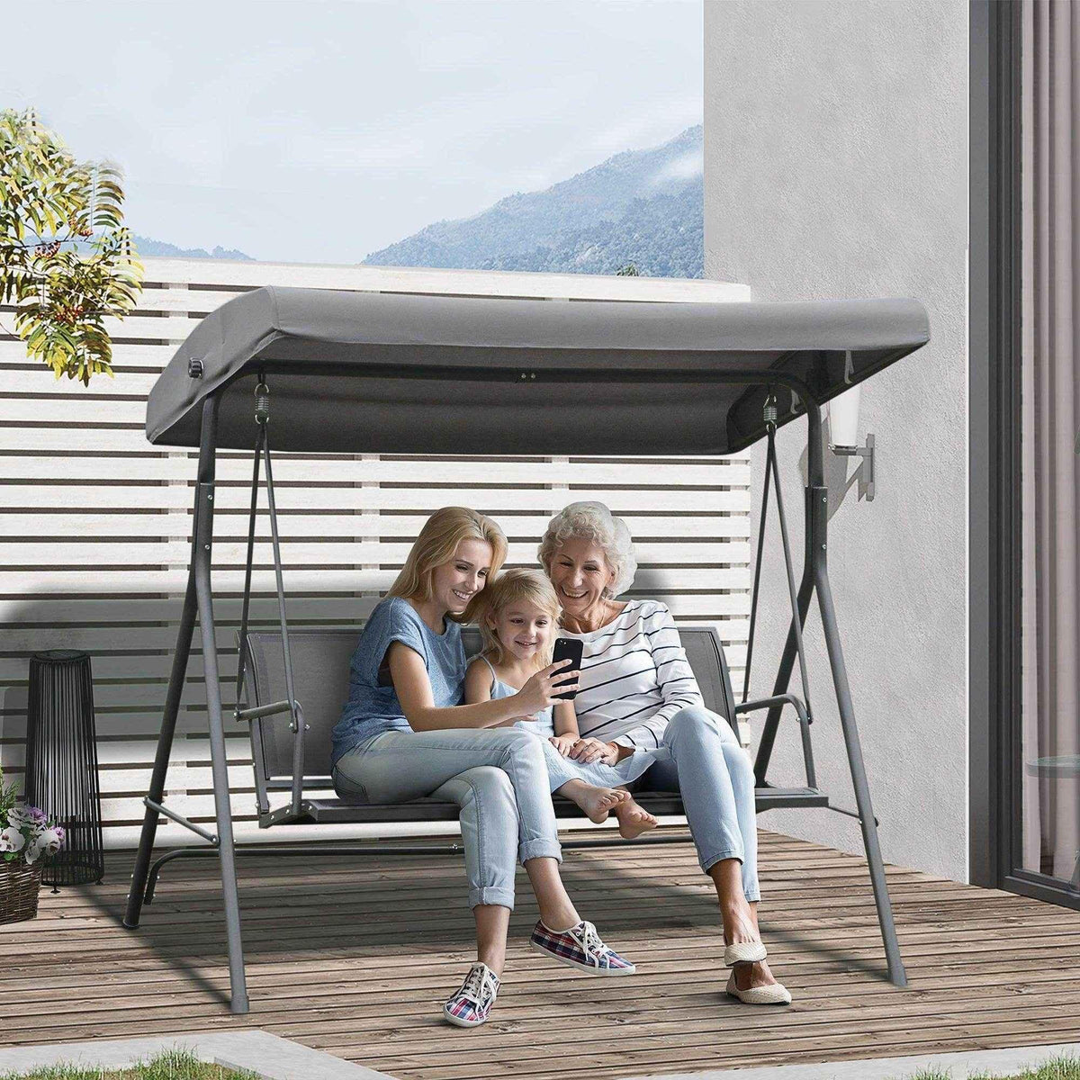 Family relaxing on outdoor patio swing with canopy, perfect for garden or deck seating