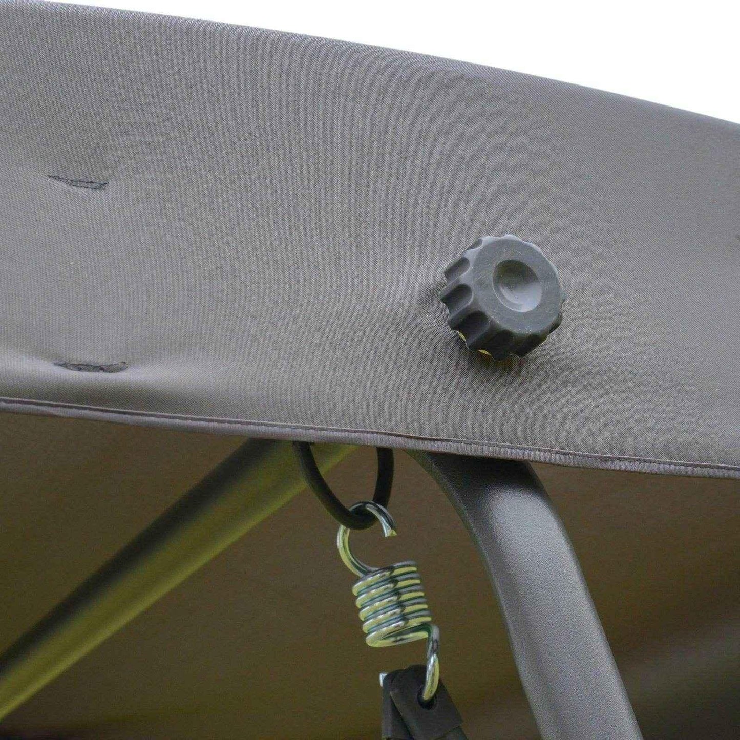 Close-up of grey fabric canopy with adjustment knob and metal spring hook on garden swing chair