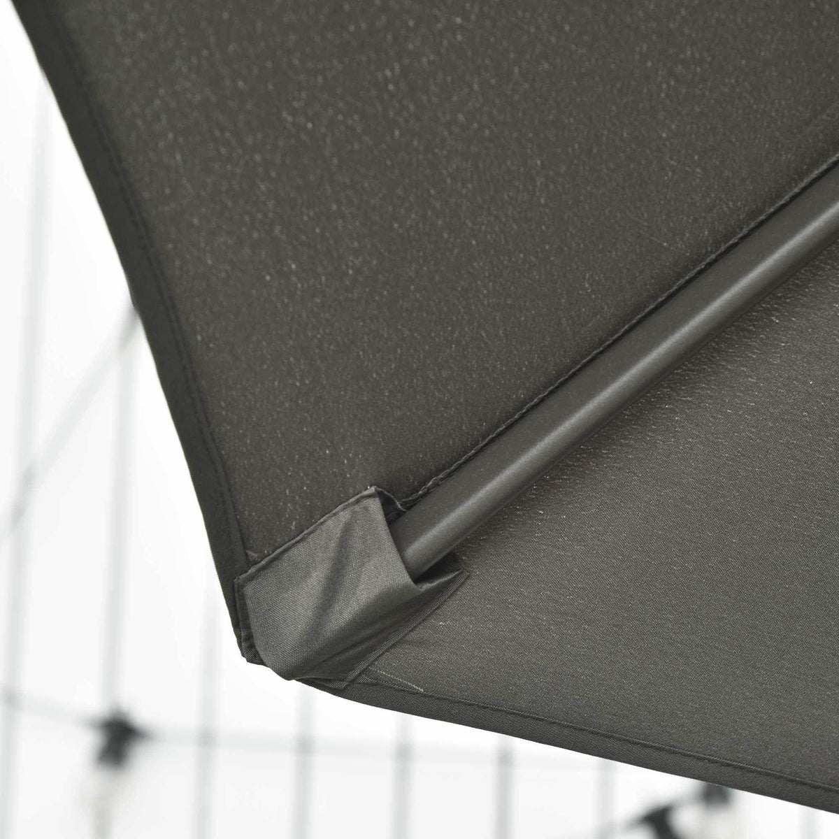 Close-up of dark grey umbrella fabric corner with stitched seam