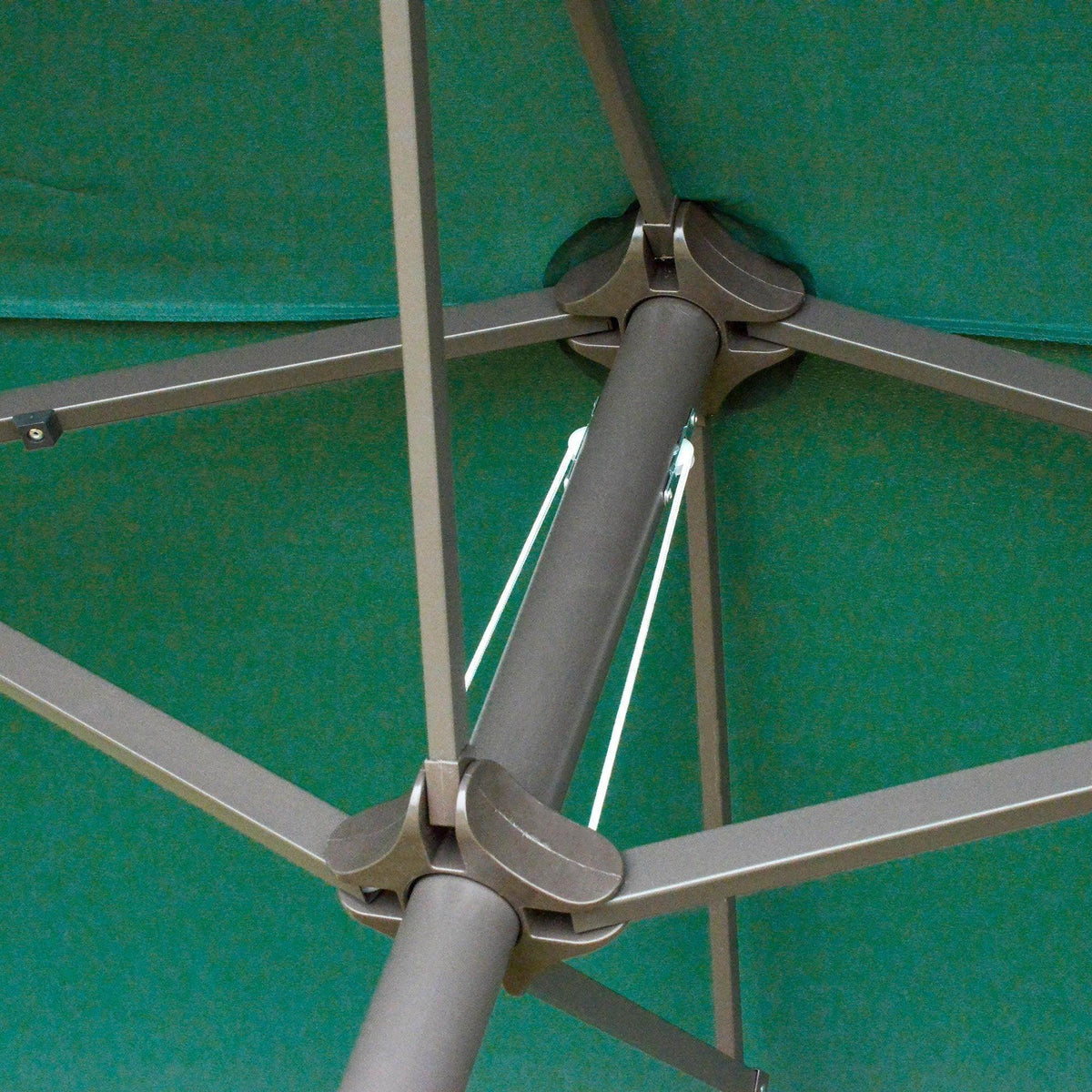 Green patio umbrella frame with metal crossbars and canopy support joints