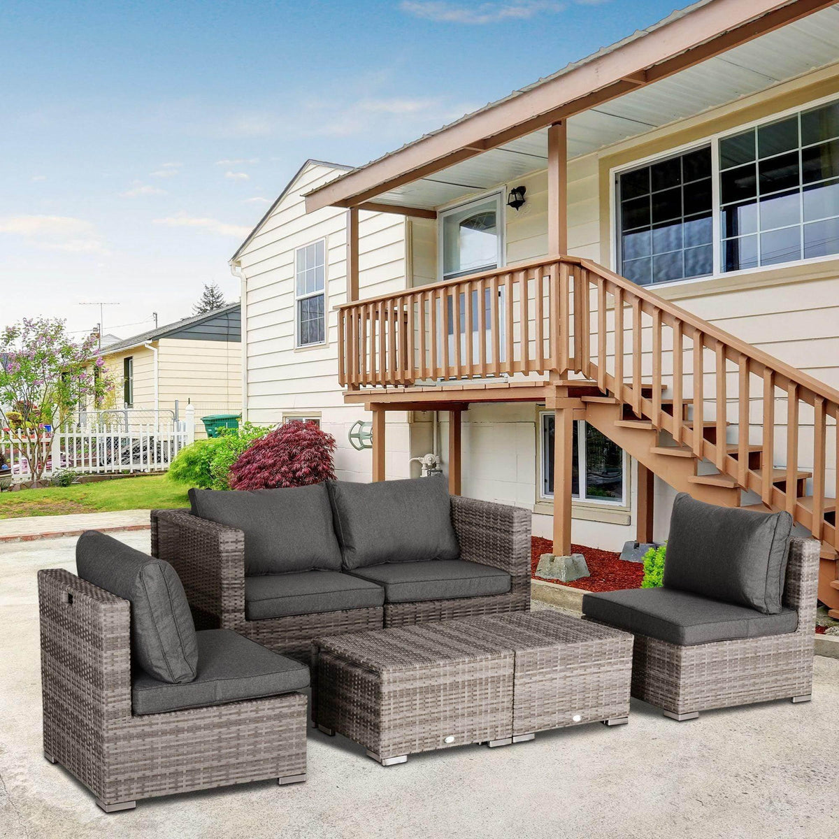 Grey outdoor rattan sectional set with seat cushions and modular corner pieces