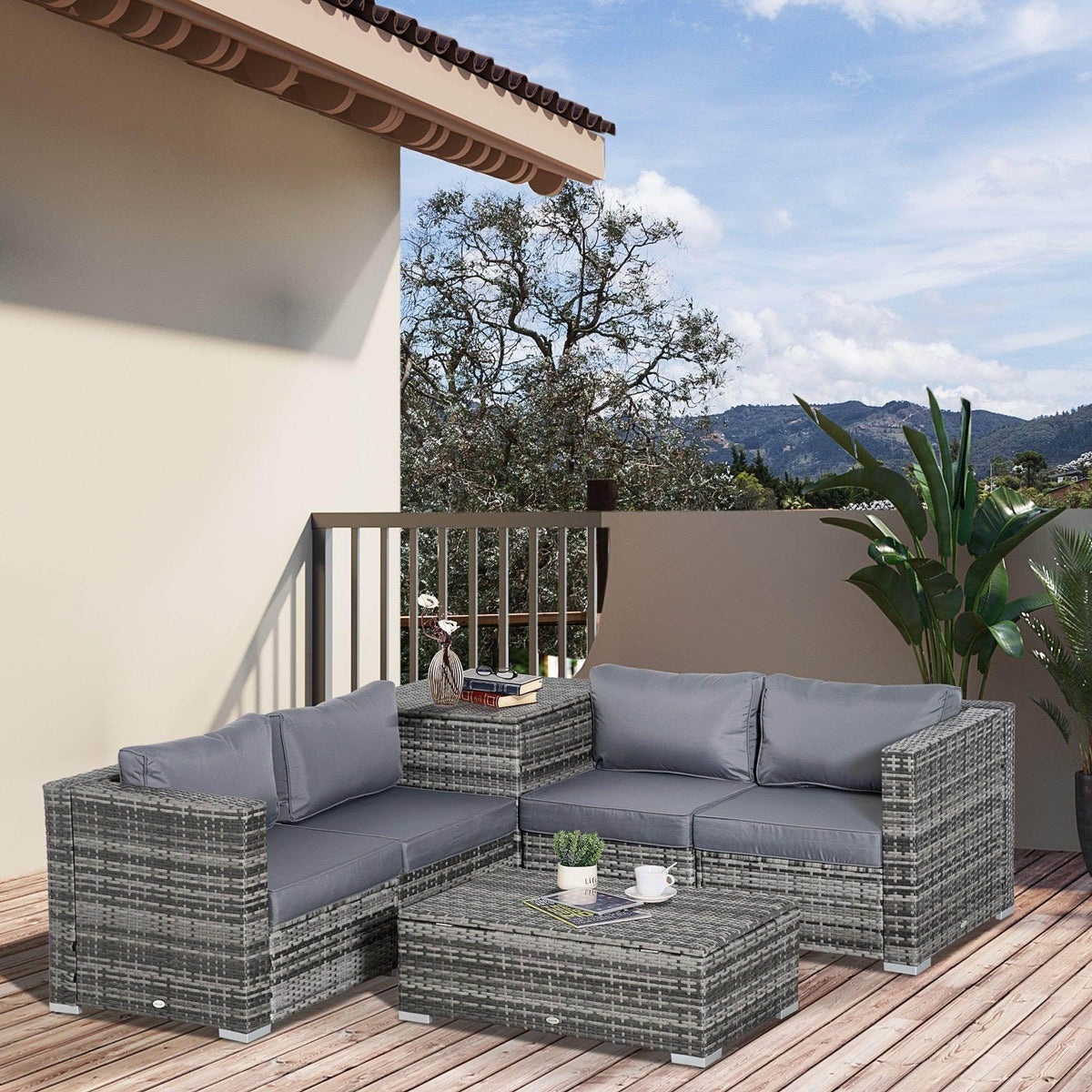 Grey rattan corner sofa set with grey cushions on an outdoor wooden deck