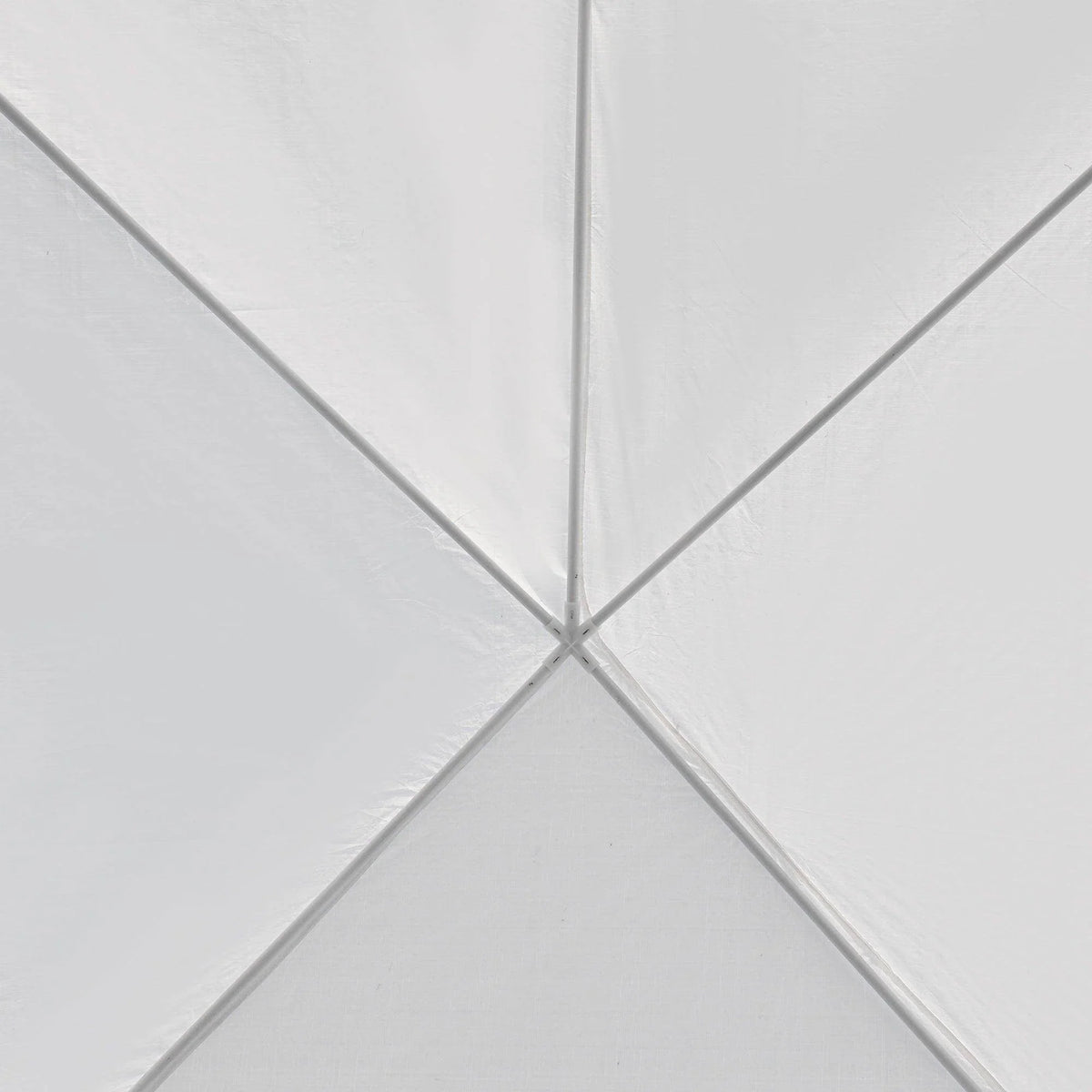 White tent canopy fabric cross seam and center pole joint, close-up