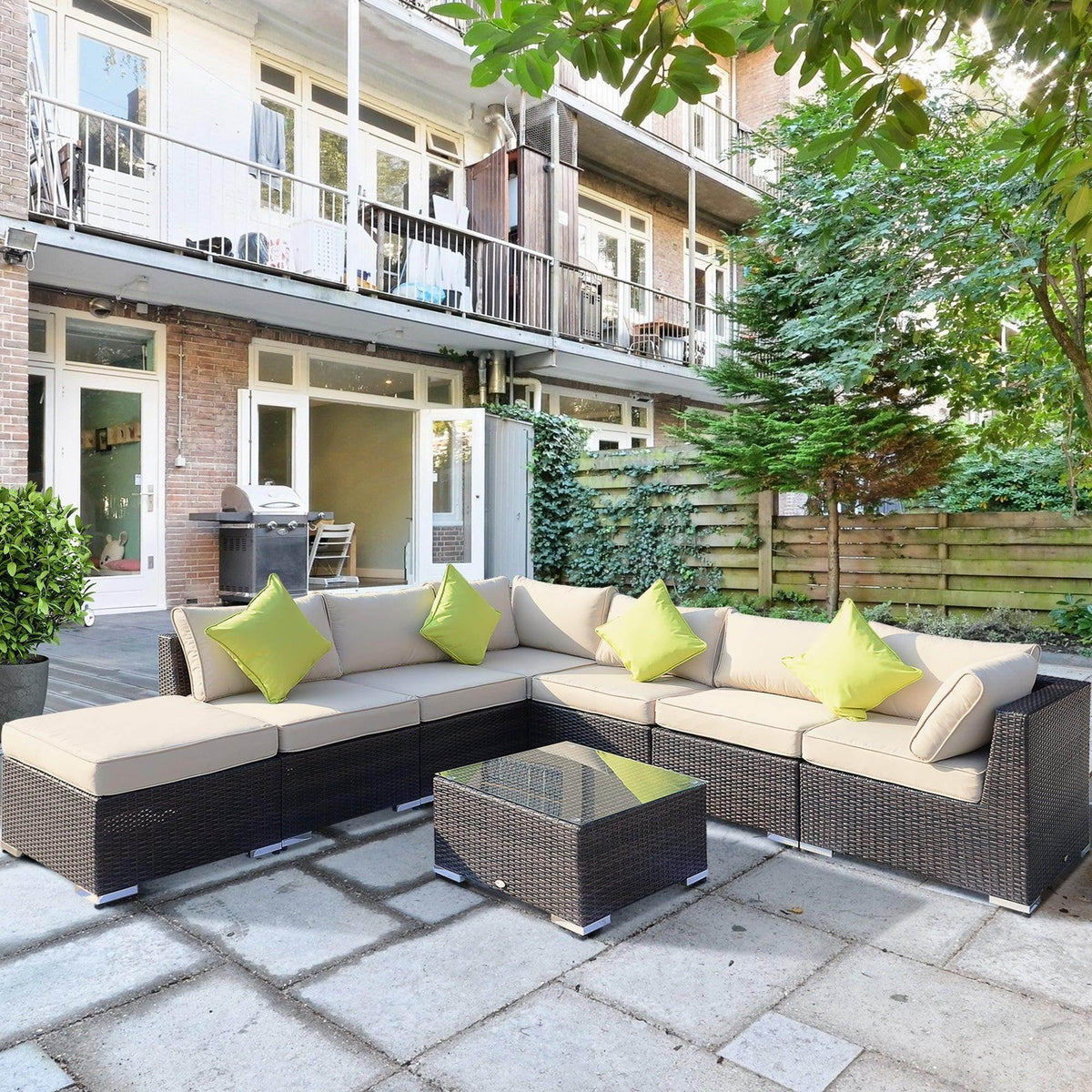 Outdoor wicker sectional sofa with beige cushions and lime green pillows on patio, perfect for garden relaxation.