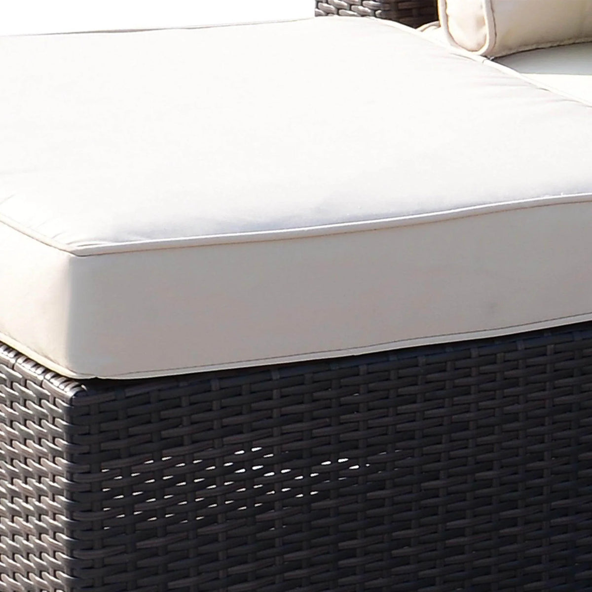 Cream outdoor cushion on dark wicker patio furniture, ideal for garden or balcony seating