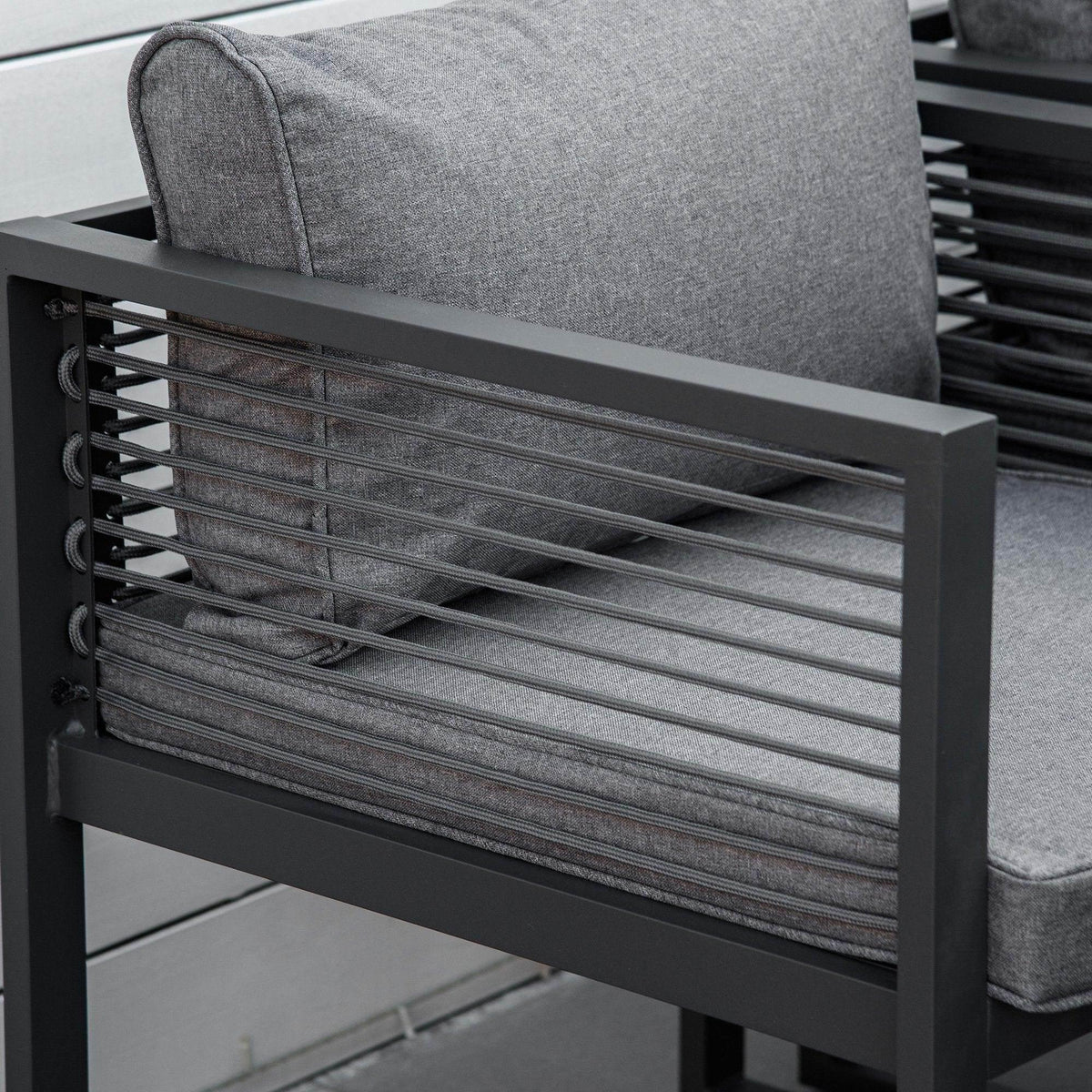 Gray padded outdoor dining chair with dark slatted back and fabric seat cushion
