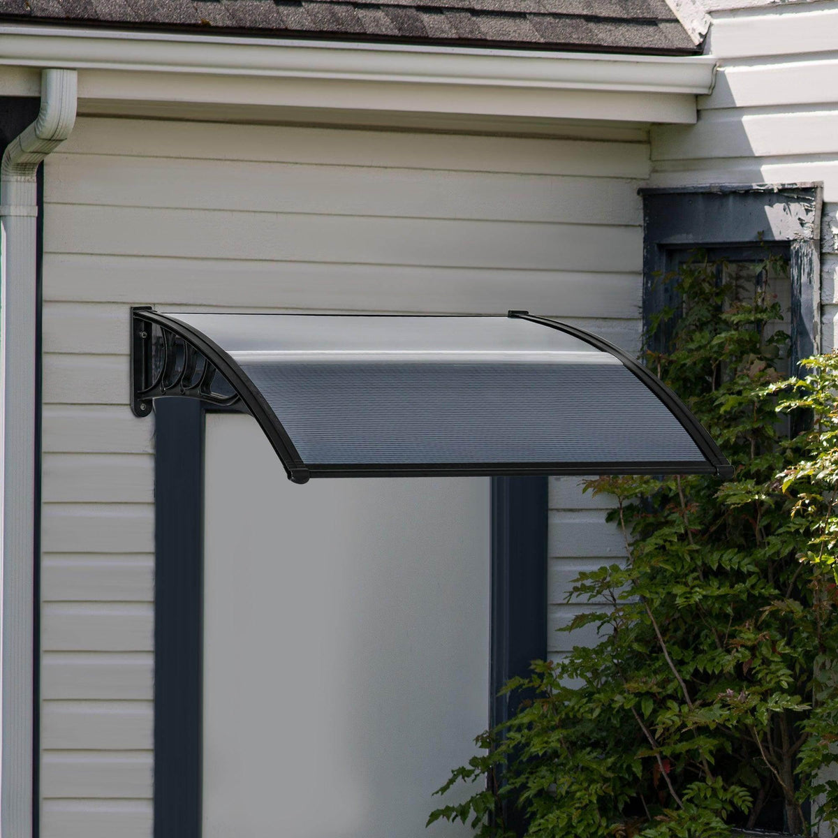 Black door canopy awning mounted above doorway with curved corner bracket and ribbed panel