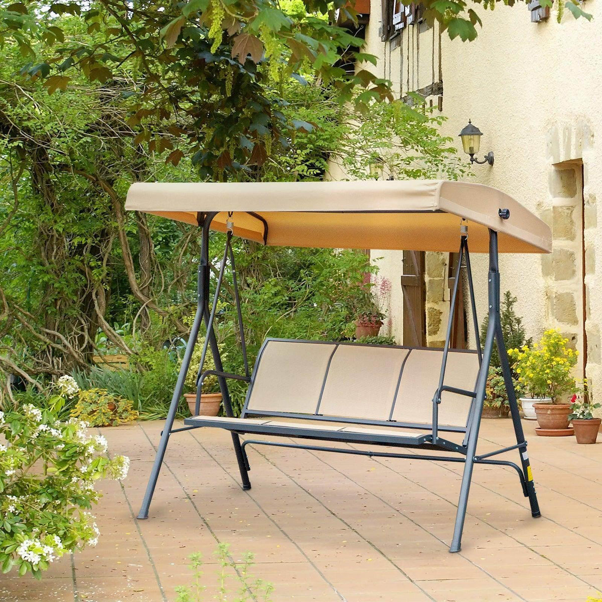 Beige canopy swing chair with two-tone seat cushions and dark A-frame steel legs.