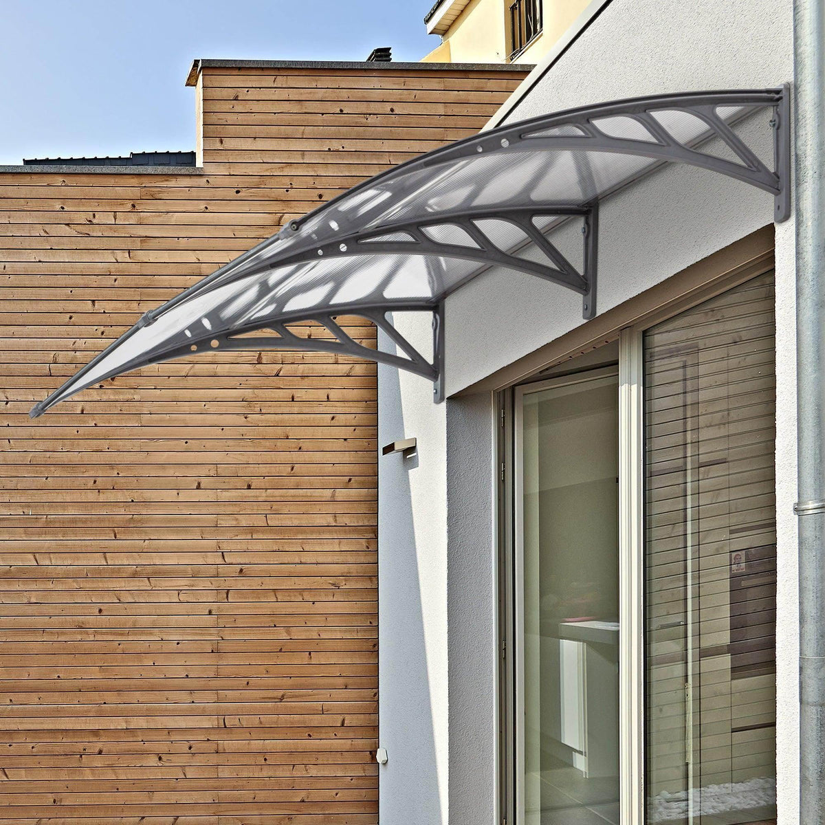 Clear door canopy awning with dark gray frame and transparent polycarbonate roof