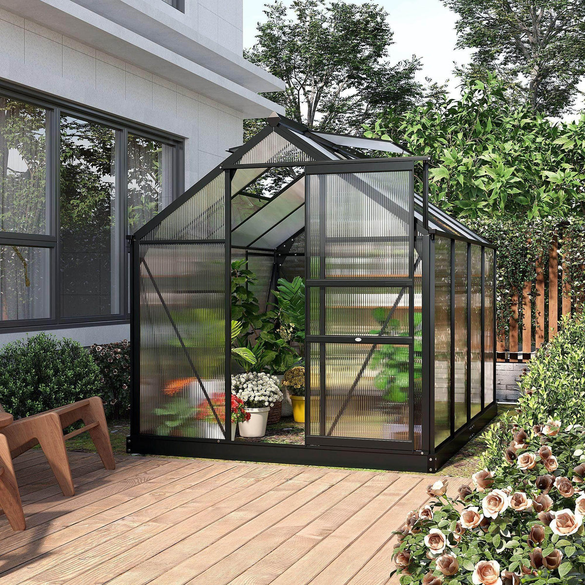 Walk-in greenhouse with clear polycarbonate walls, black aluminum frame, sliding door