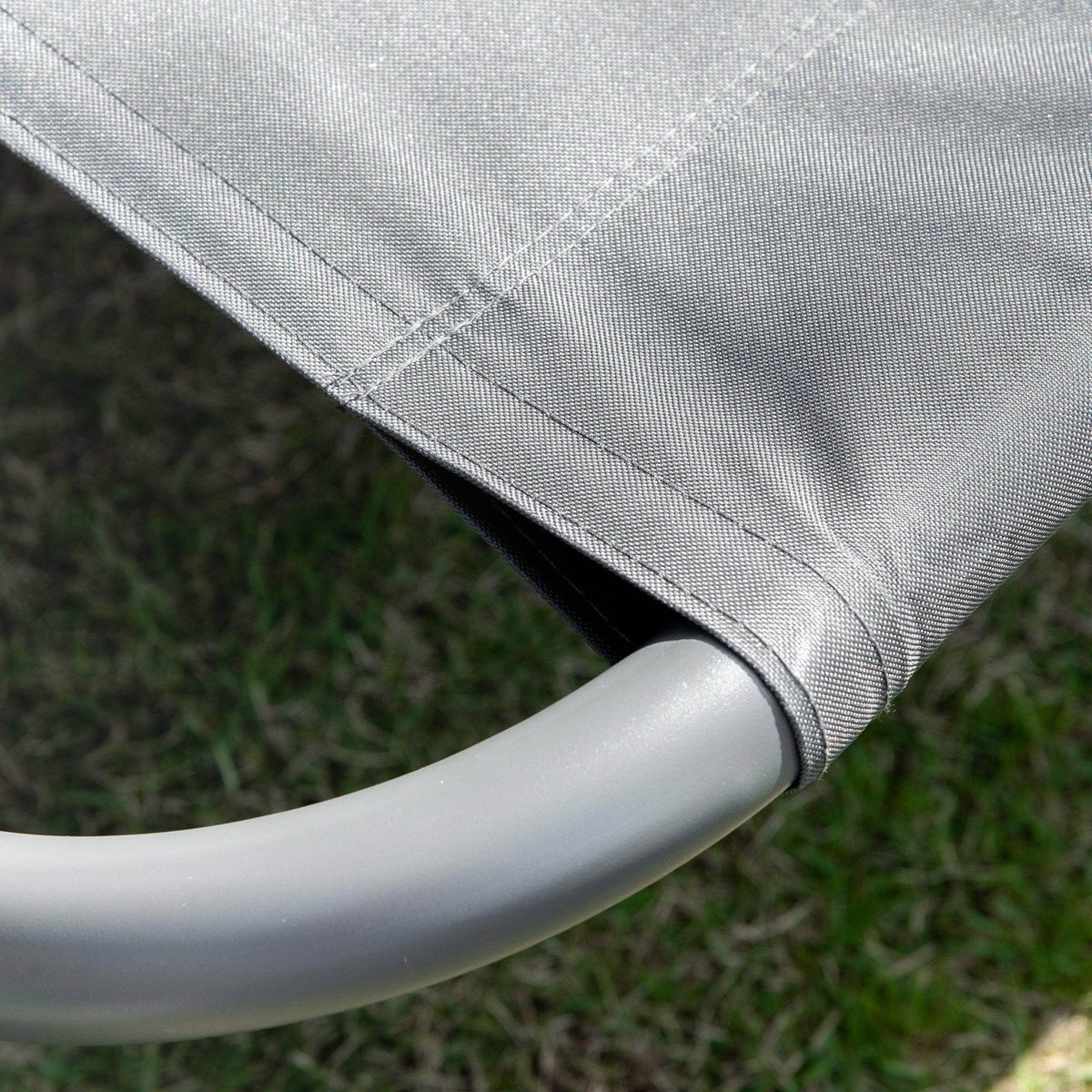 Grey fabric edge detail on curved metal arm of hammock daybed lounger