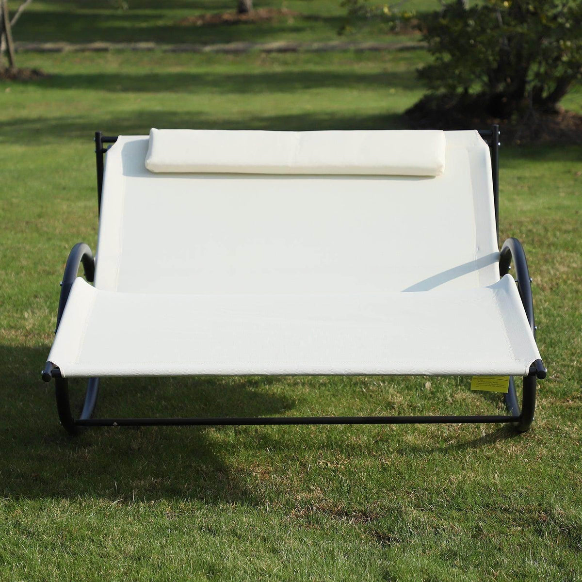 Beige double sun lounger with pillow, padded seat cover on black metal rocker base