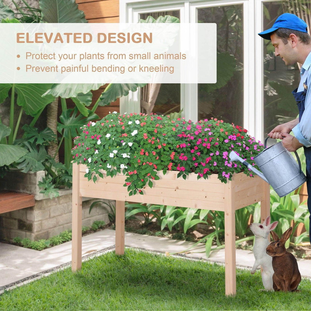 Elevated wooden planter outdoors with flowers, viewed as someone pours water nearby