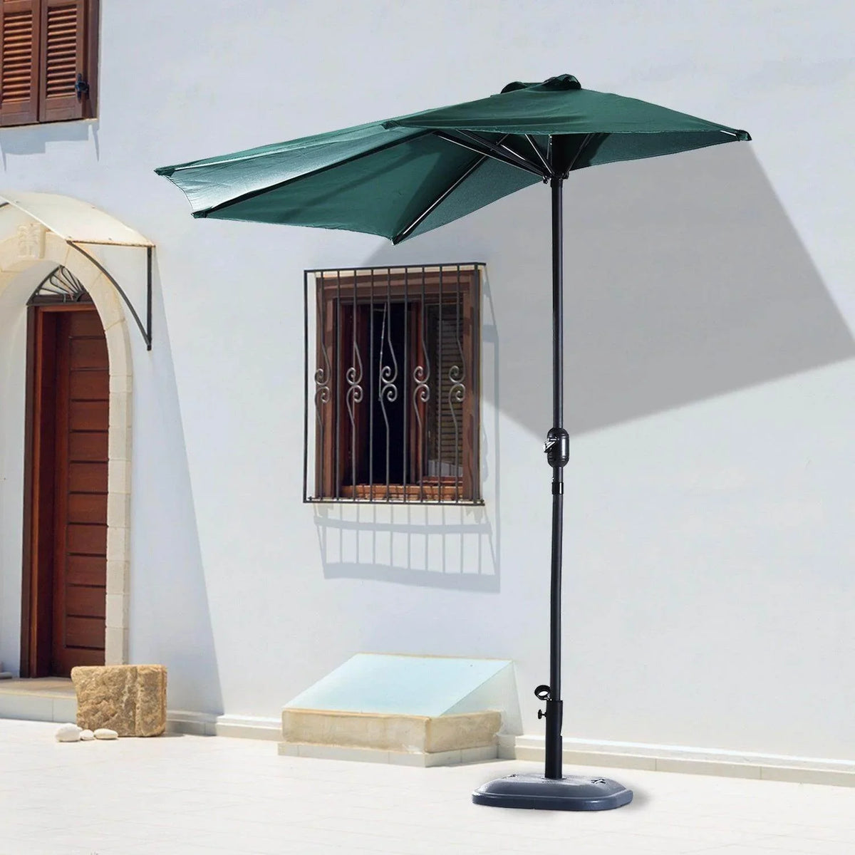 Dark green half balcony parasol umbrella with black pole and round weighted base