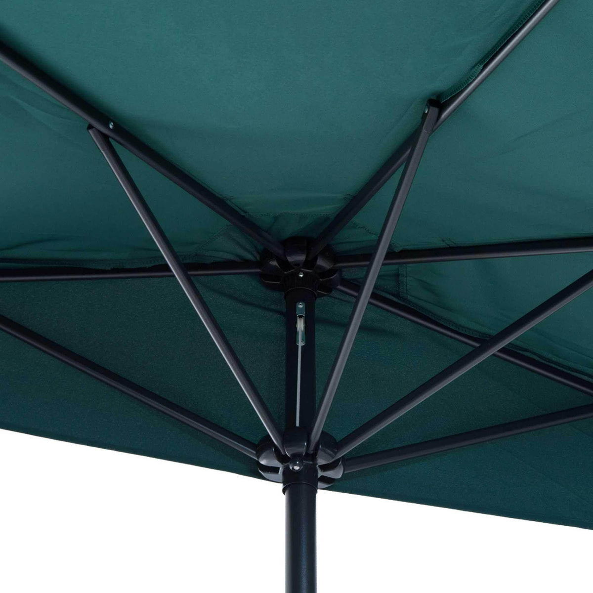Dark green umbrella canopy underside view with cross ribs and central hub on pole