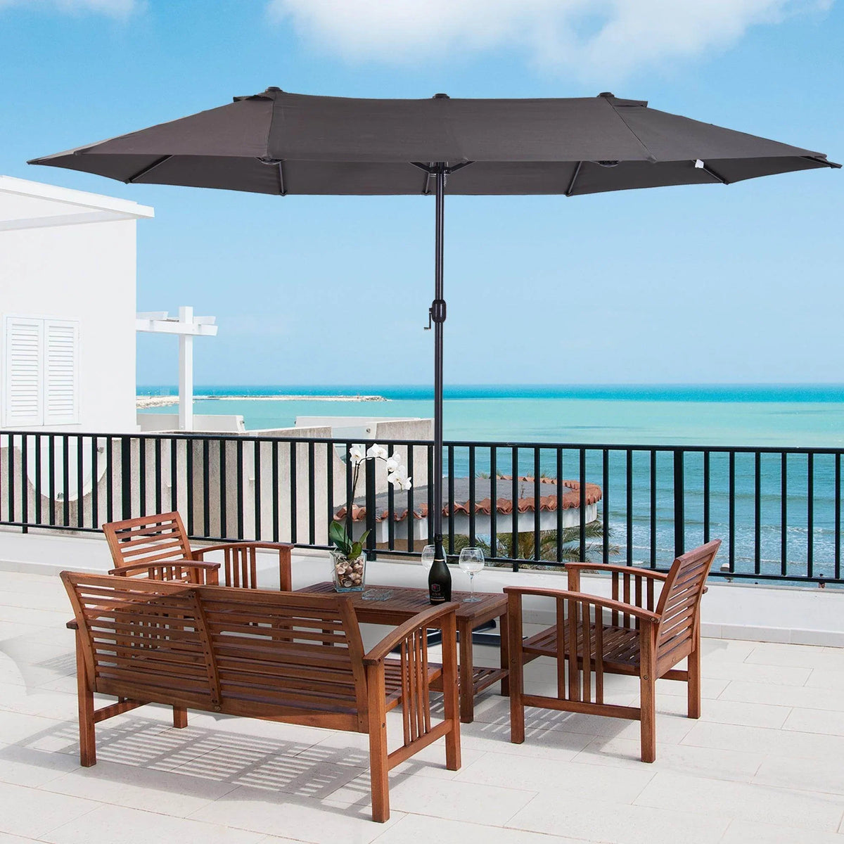 Open outdoor patio parasol with dark gray canopy and central pole