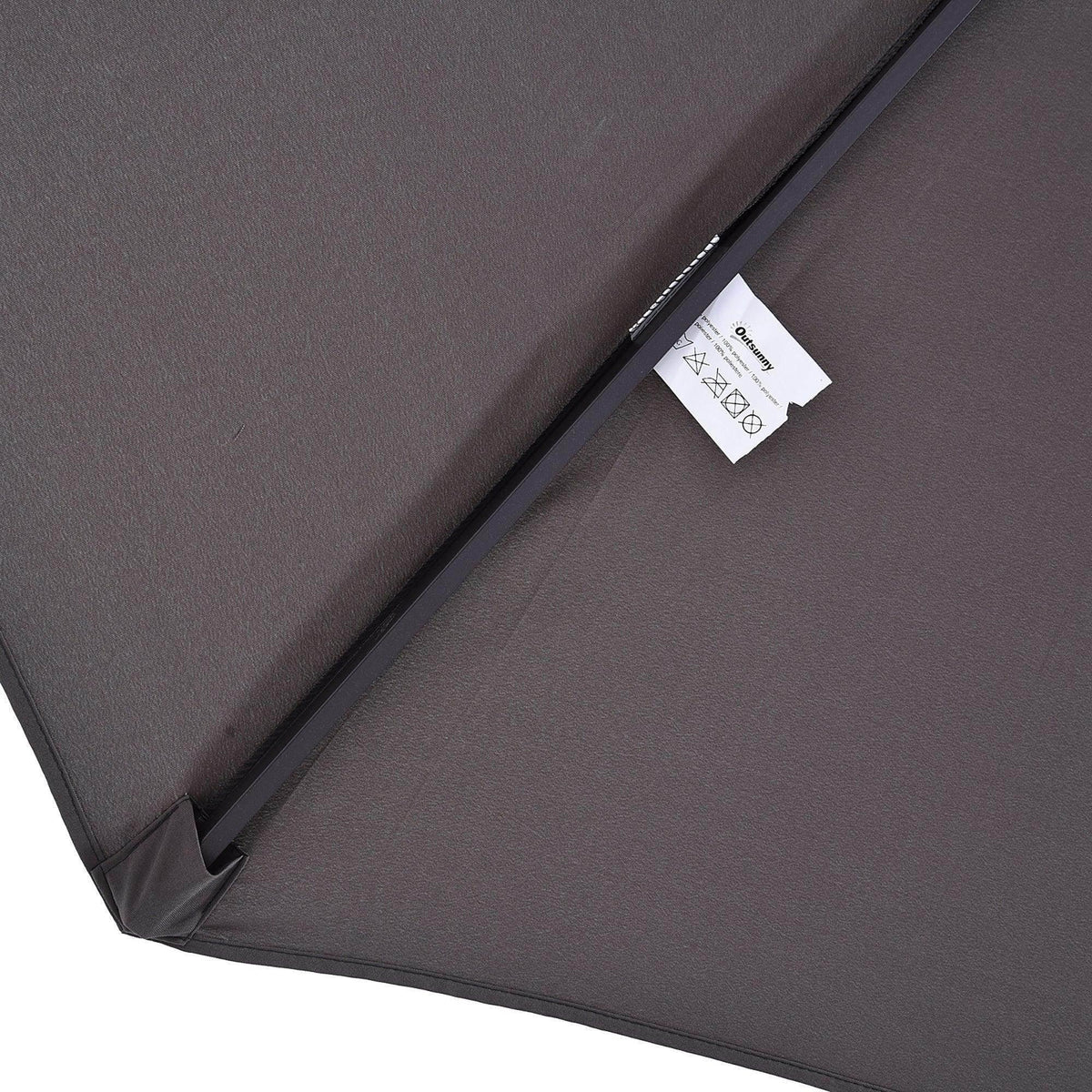 Dark gray umbrella canopy fabric with stitched seam and attached label
