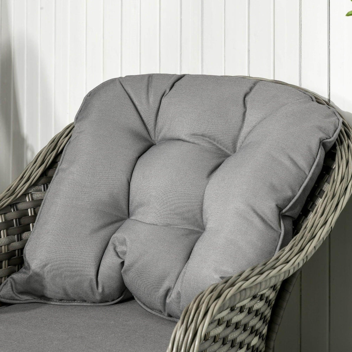 Grey tufted outdoor sofa back cushion with thick, padded upholstery close-up