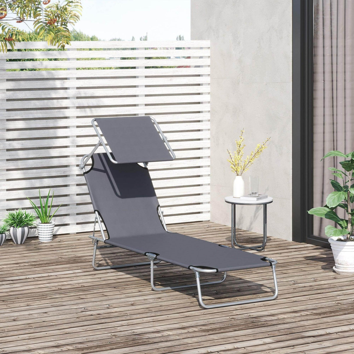Dark grey reclining sun lounger with adjustable backrest for outdoor use