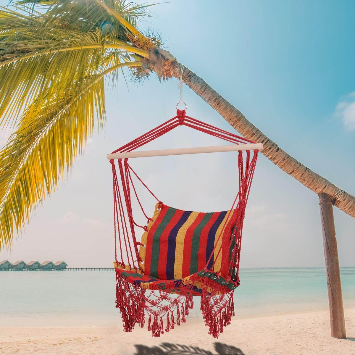 Multicolor striped hanging hammock chair with red ropes and fringe tassel trim.