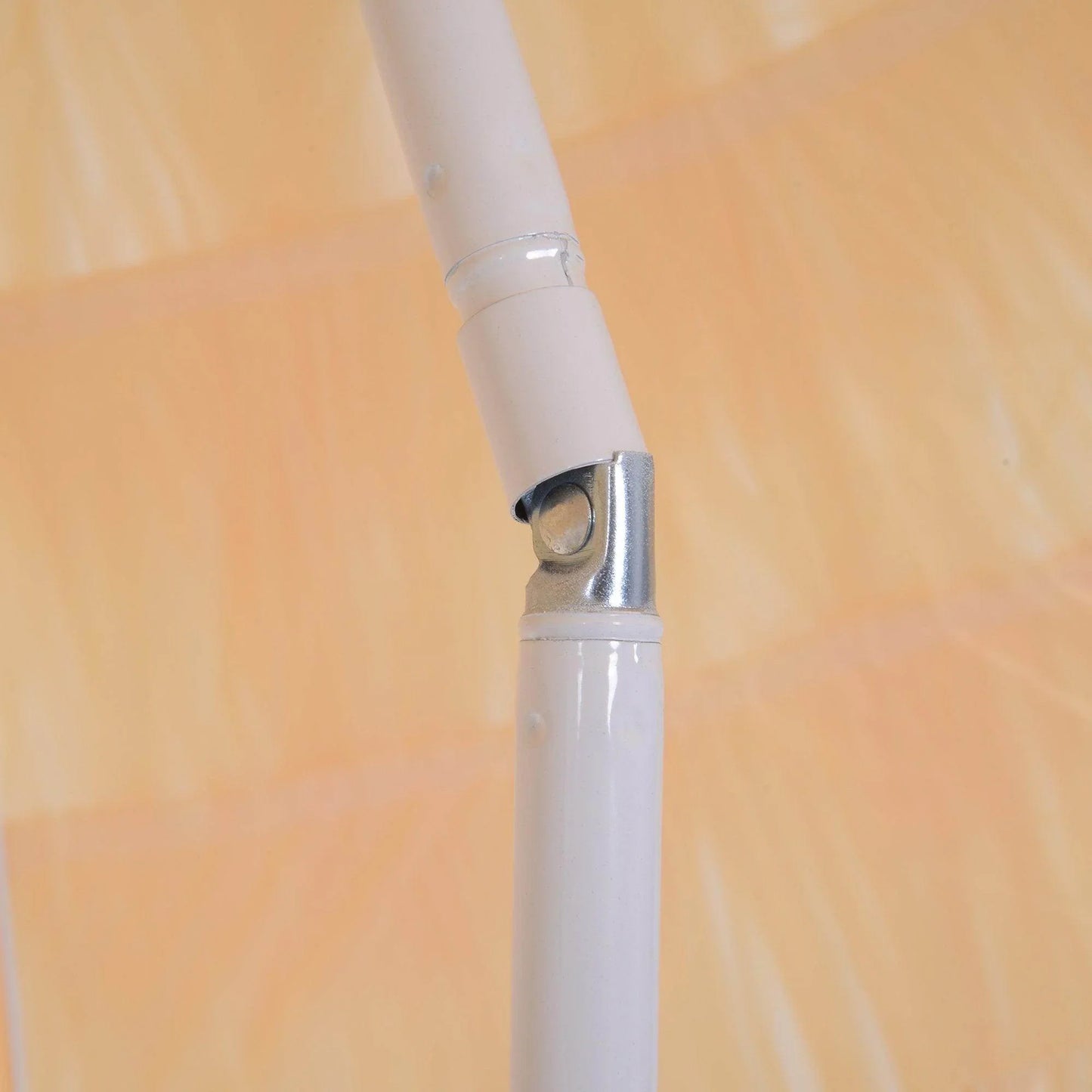 Close-up of adjustable white beach umbrella pole joint against a wheat yellow fabric canopy.