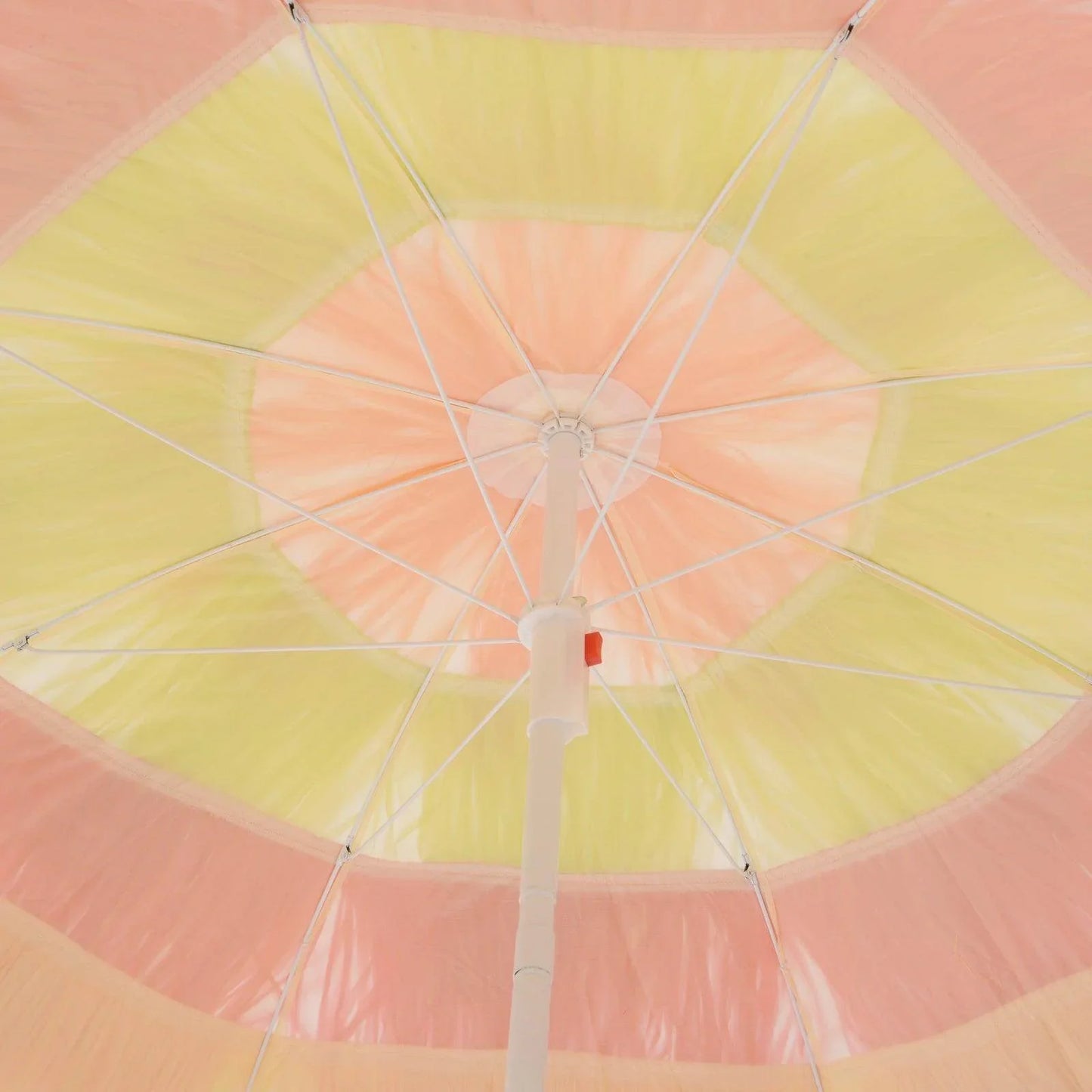 View under pastel yellow and pink beach umbrella with sturdy white pole and metal spokes