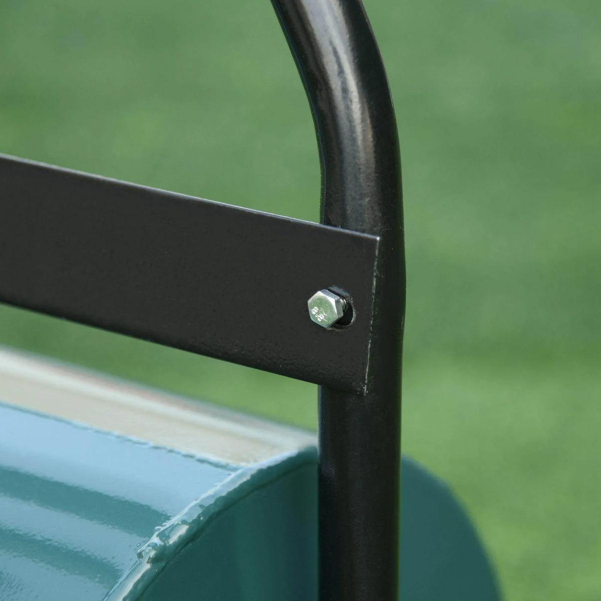 Black handle support bracket with screw detail on teal lawn roller drum