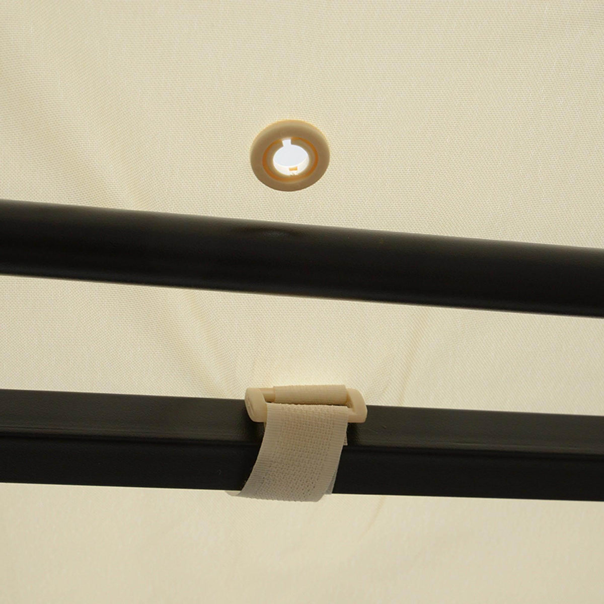 Cream-white fabric canopy edge with dark metal beam and circular grommet