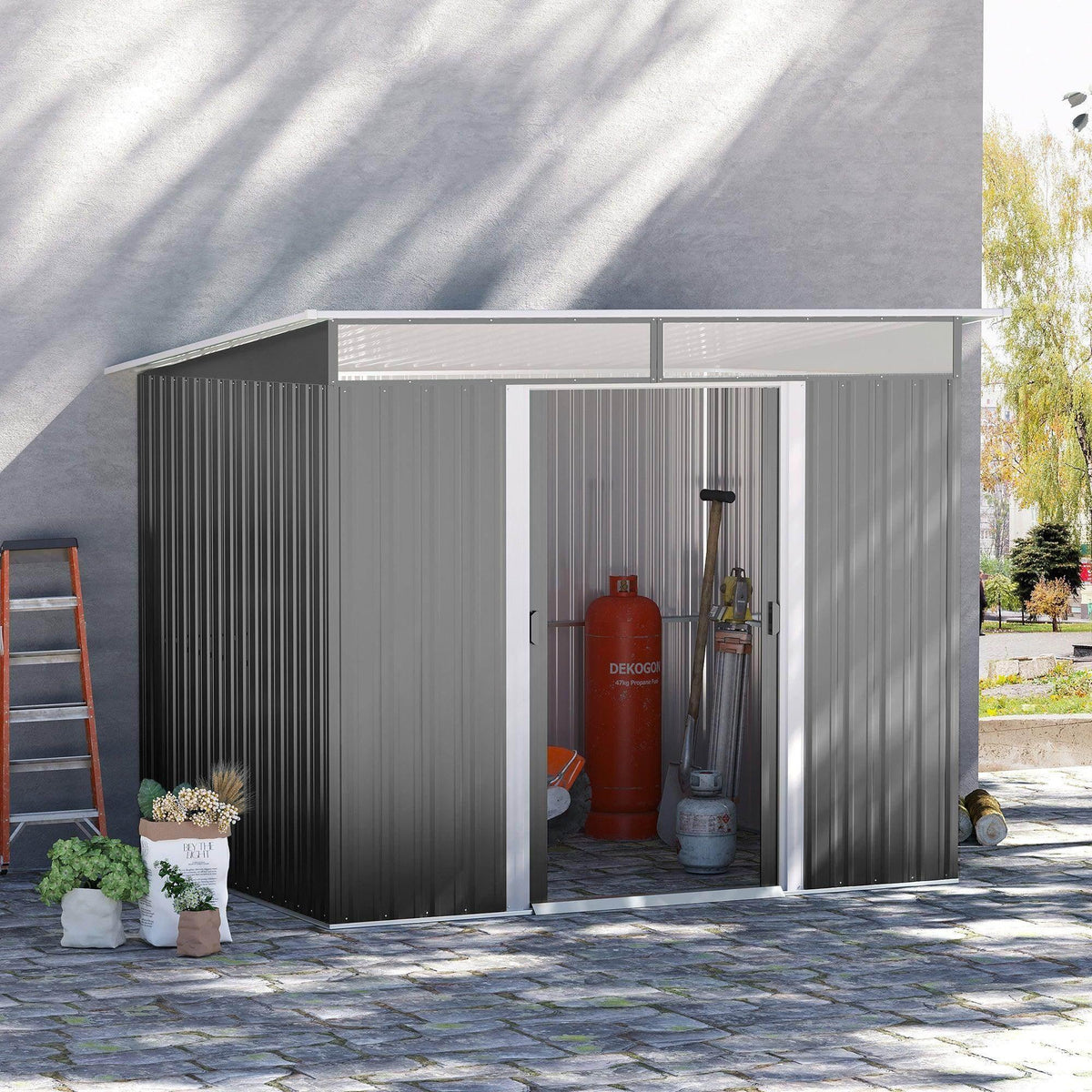 Grey metal storage shed with tilted roof and double sliding doors, front opening view