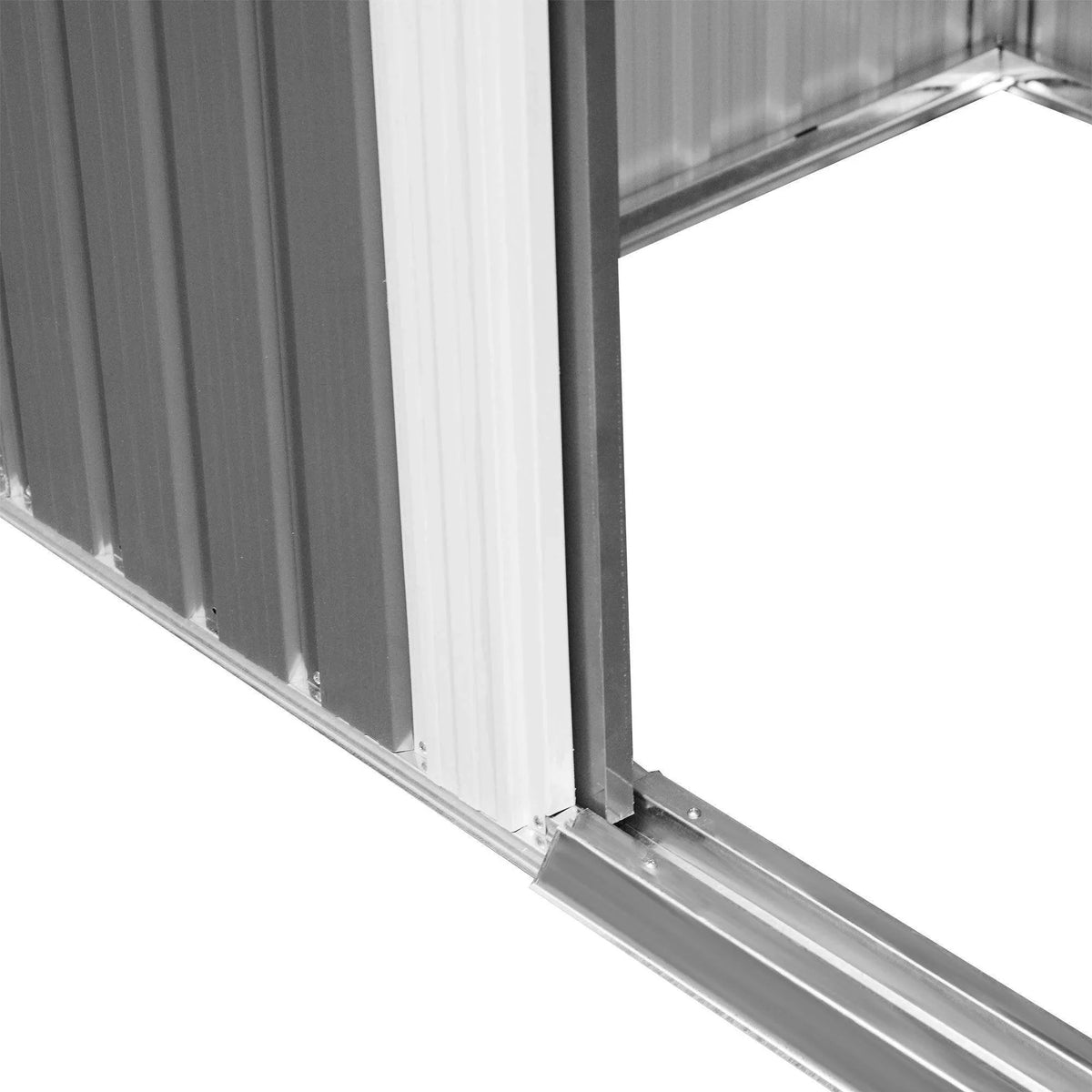 Metal shed corner detail with galvanized base rail and vertical wall panel seams