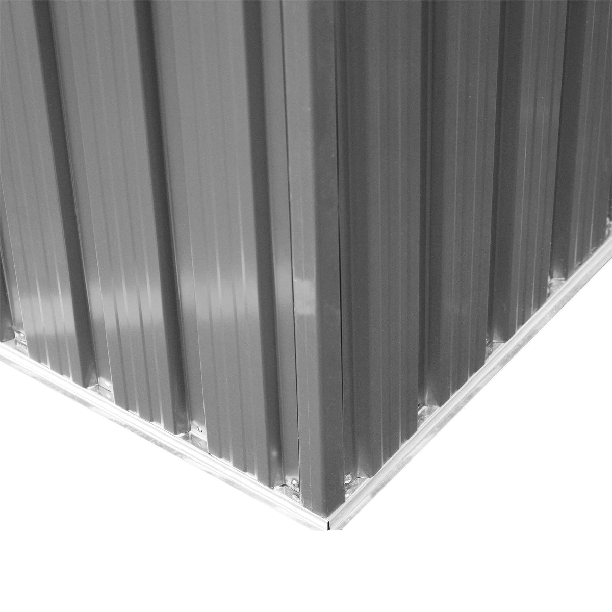 Metal shed corner detail with vertical corrugated panels and bottom edge trim