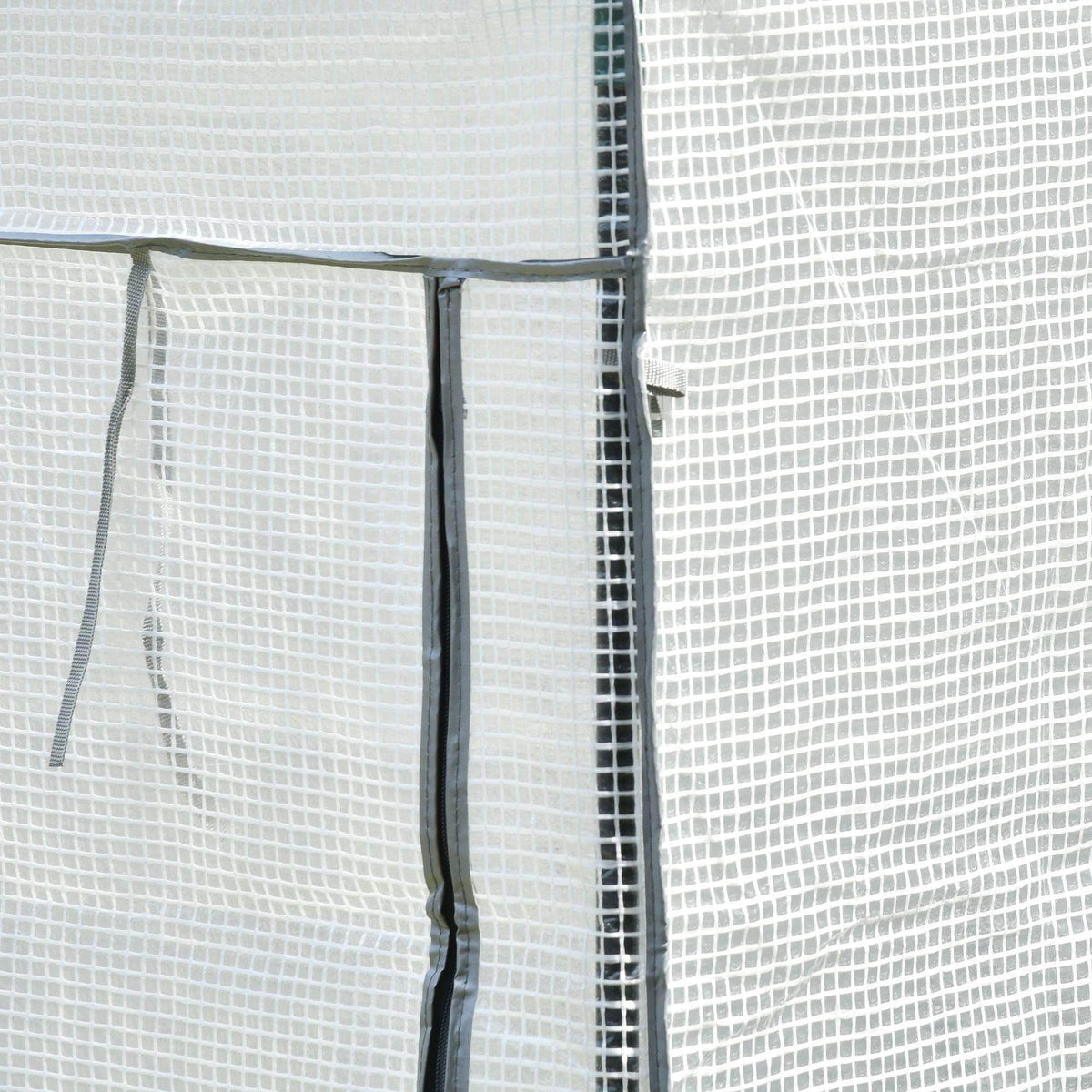 Close-up of greenhouse mesh side panel seam and roll-up door ties