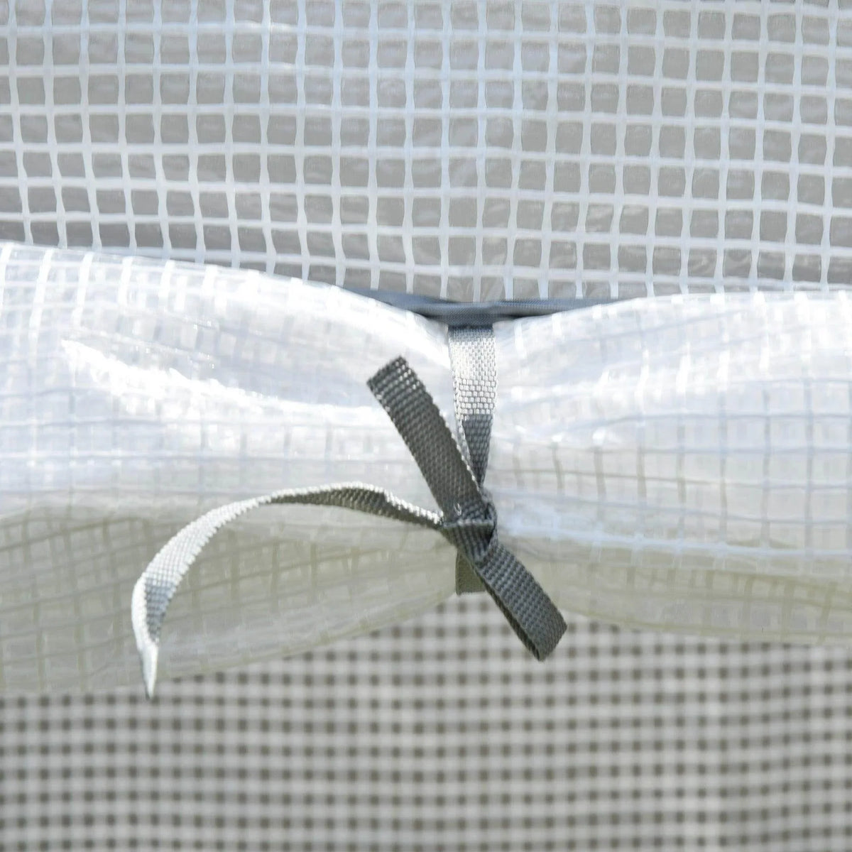 Greenhouse cover roll-up tie strap attached with reinforced fabric loop