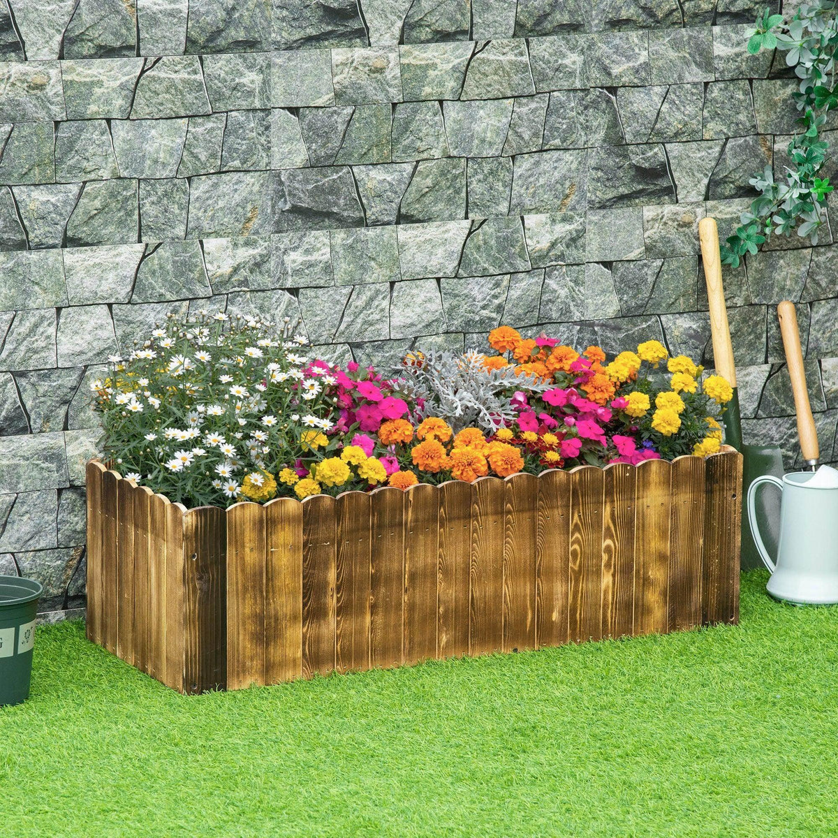 Rectangular wooden raised garden bed with vertical slat sides and colorful flowers inside.