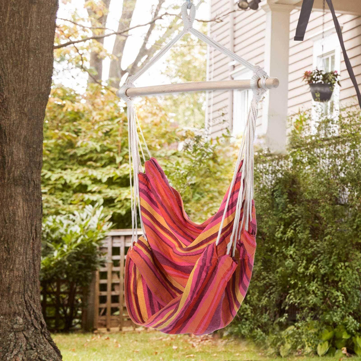 Striped cotton hammock swing chair with wooden spreader bar and hanging ropes
