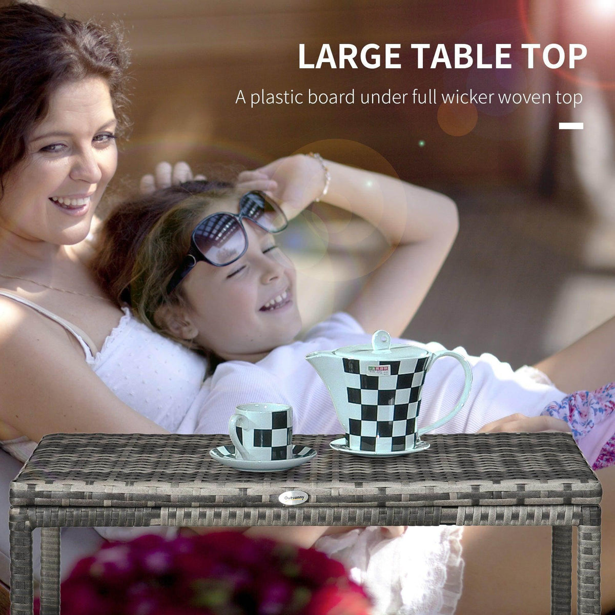 Grey woven rattan coffee table with braided edge, two checkered mugs on top