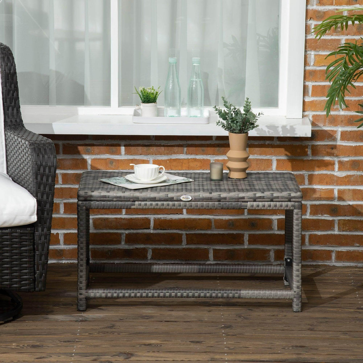 Grey woven rattan outdoor coffee table with open lower shelf and side view