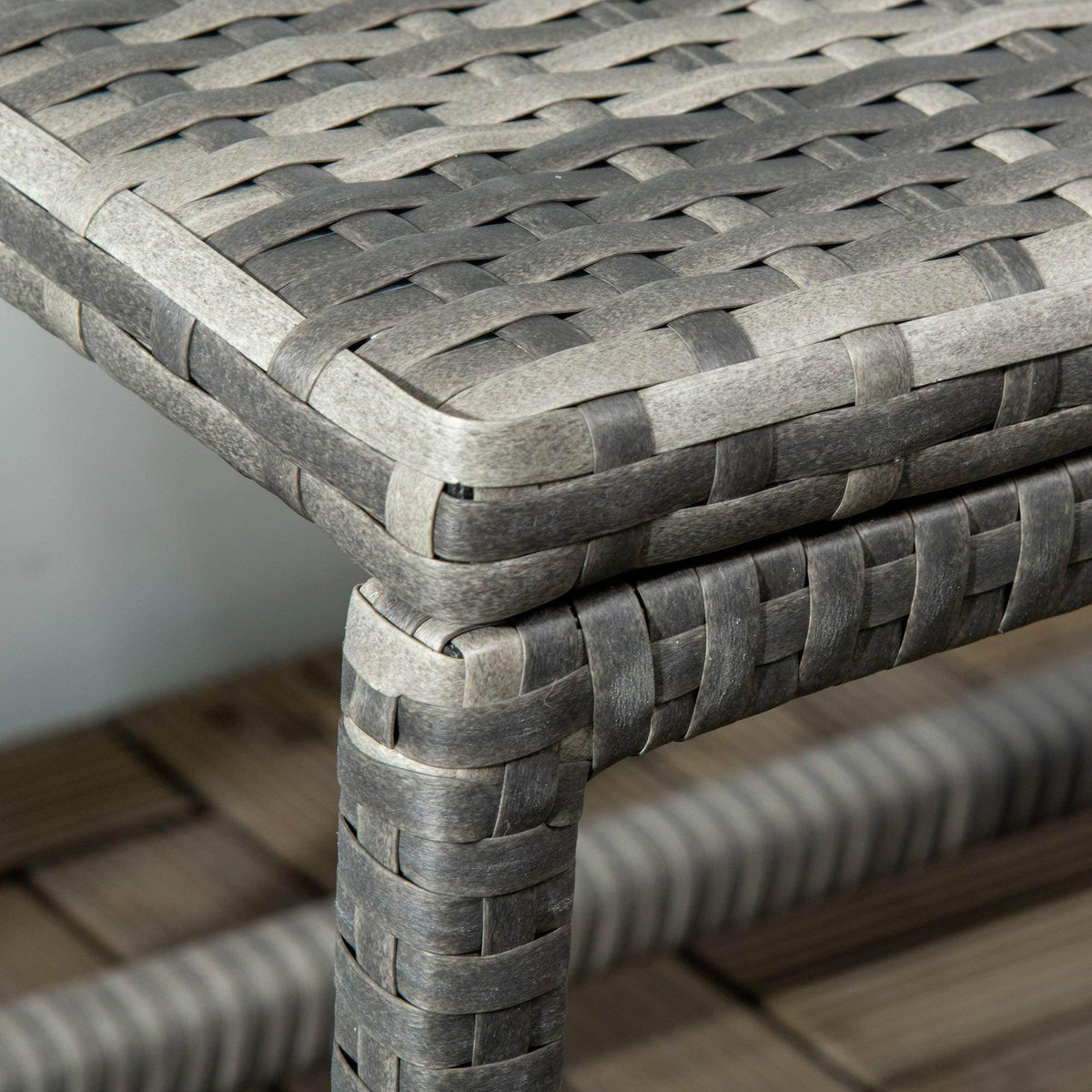 Grey woven rattan corner and leg detail with rounded post and braided trim