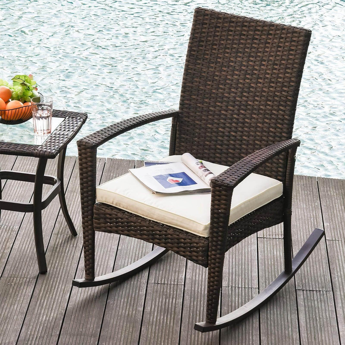 Brown rattan rocking chair with curved arms and seat cushion