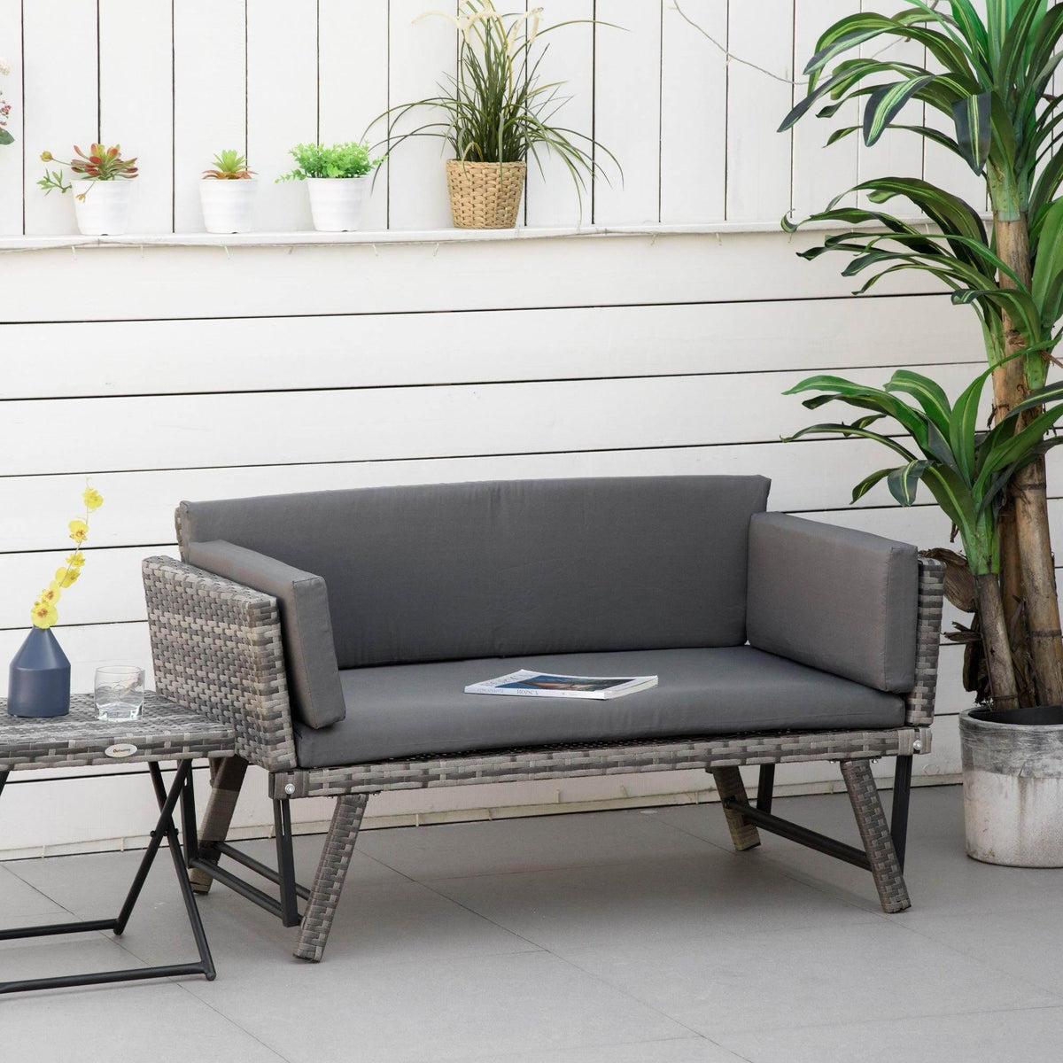 Outsunny outdoor rattan sofa bed in grey with upholstered back and seat cushions