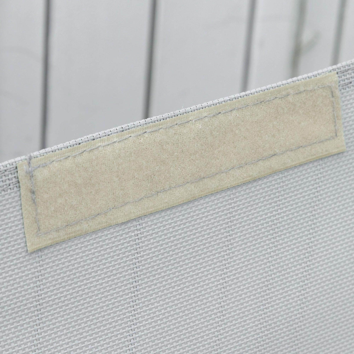 Grey mesh backrest panel with stitched edge on rocking lounge chair